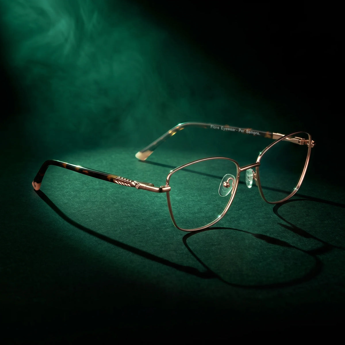 Fiore 2210 eyeglasses in gold pink – under a theatrical beam of light