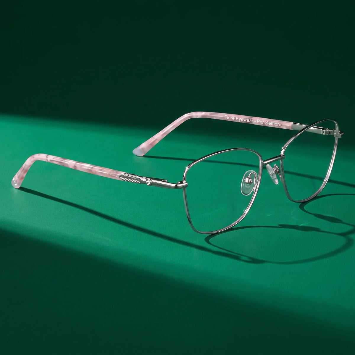 Fiore 2210 eyeglasses in silver black – still life on a seamless emerald studio backdrop
