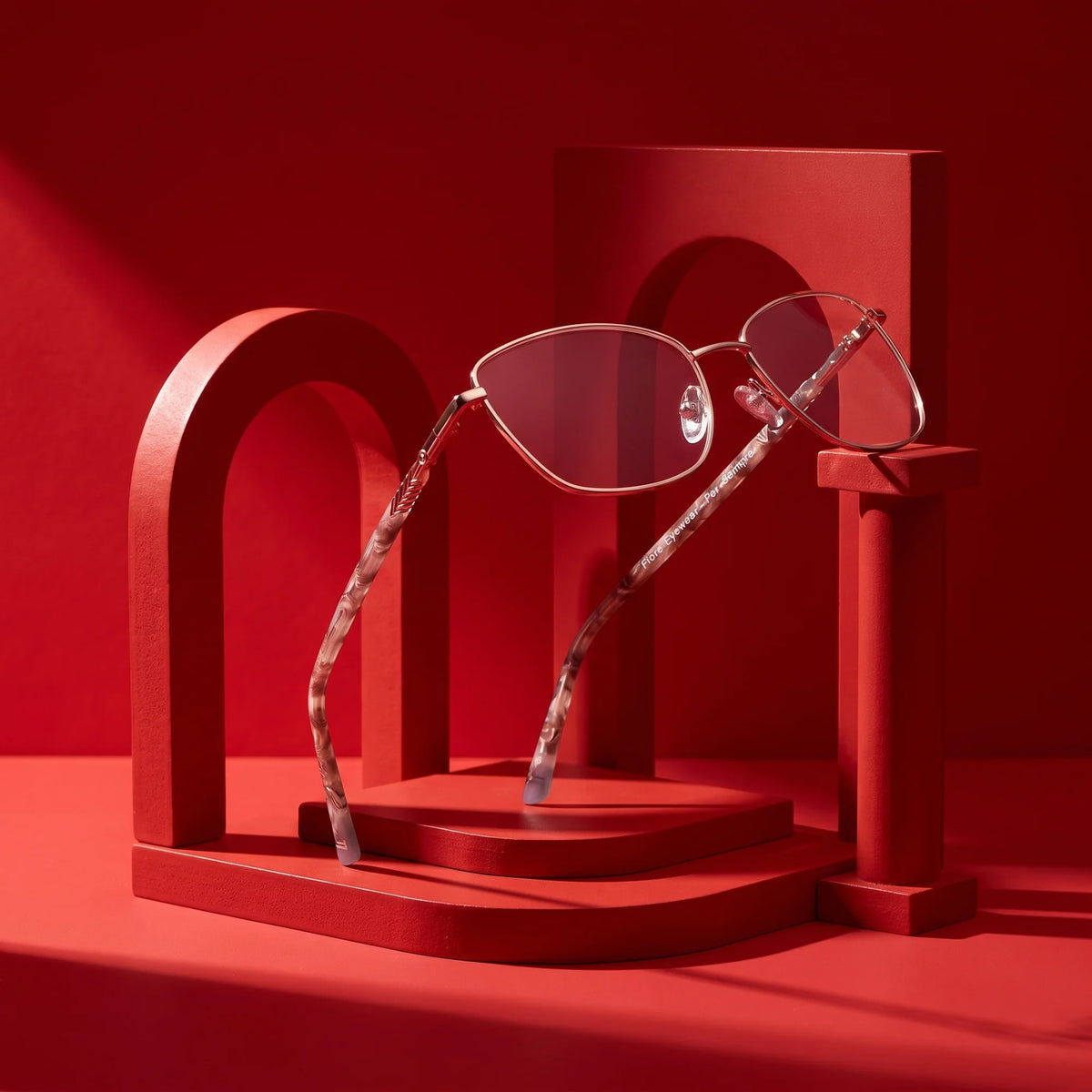 Fiore 2210 eyeglasses in gold brown – still life among monochrome vivid red arches