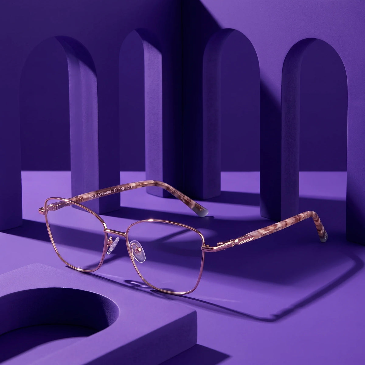 Fiore 2210 eyeglasses in gold brown – staged on a sculptural violet architecture set