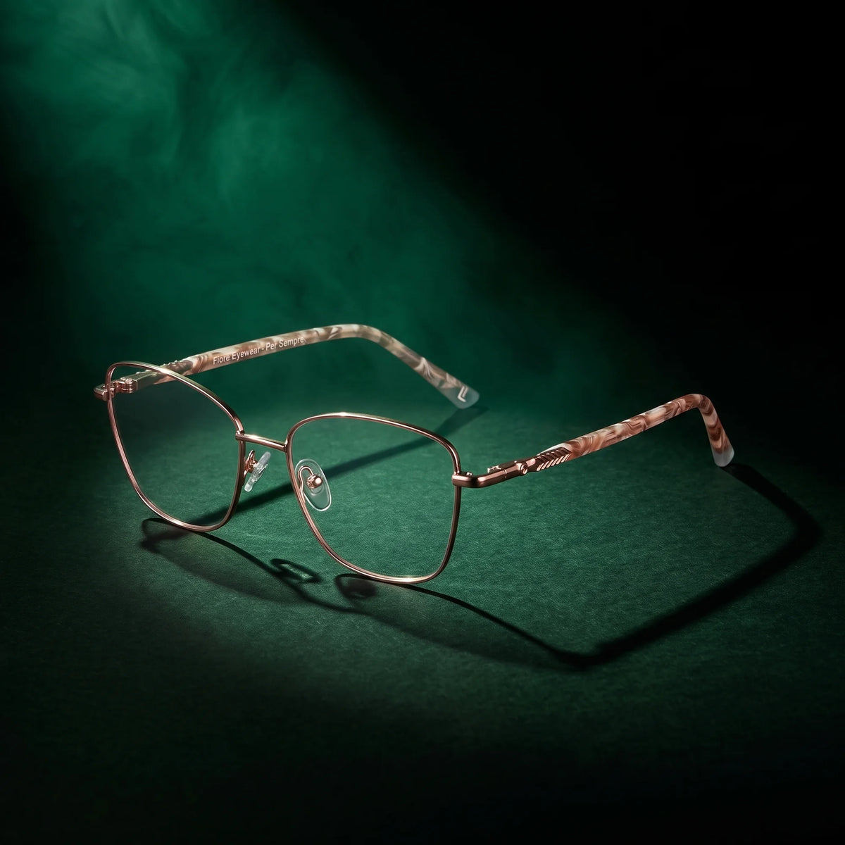 Fiore 2210 eyeglasses in gold brown – under a theatrical beam of light