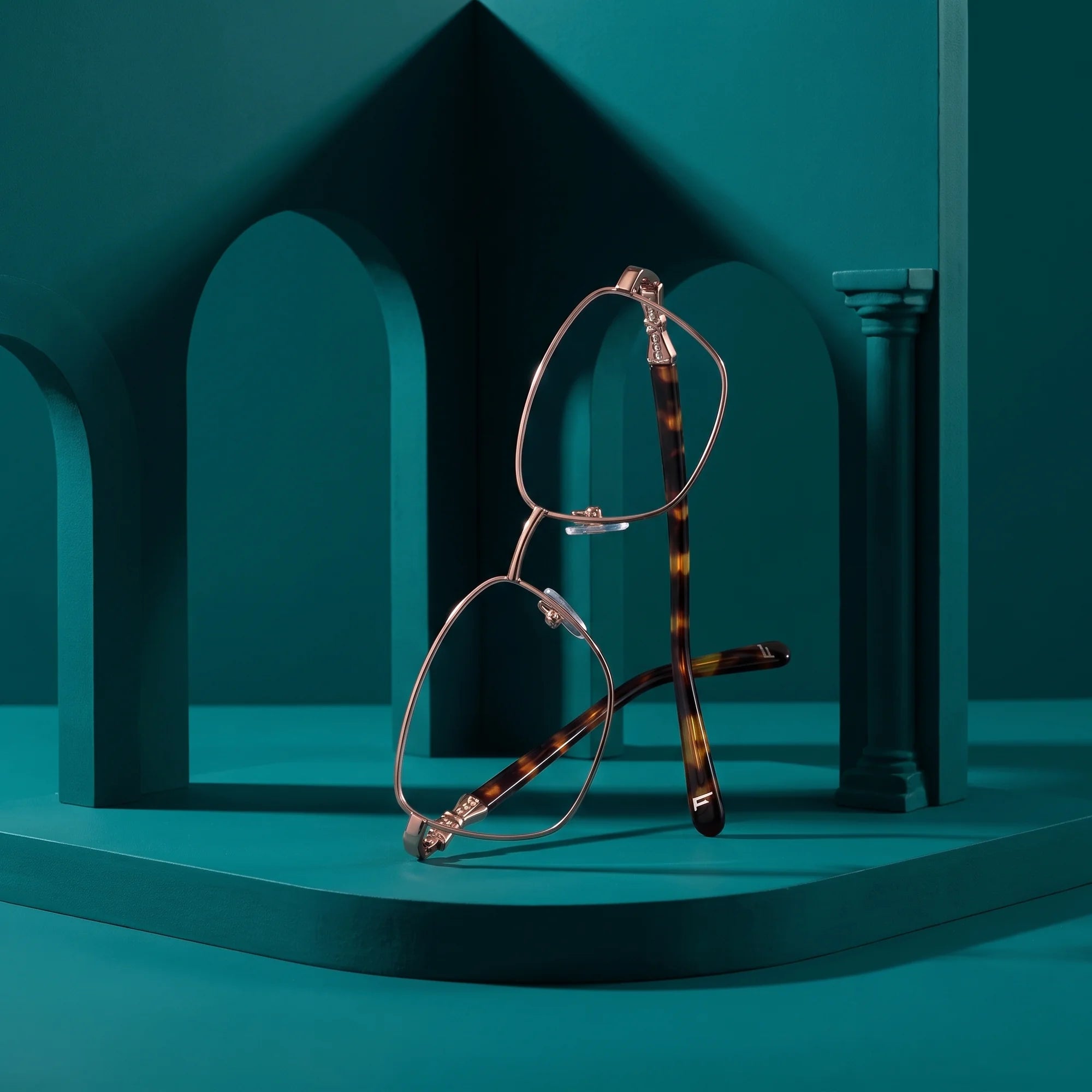 Fiore 22115 eyeglasses in brown – still life among monochrome teal arches