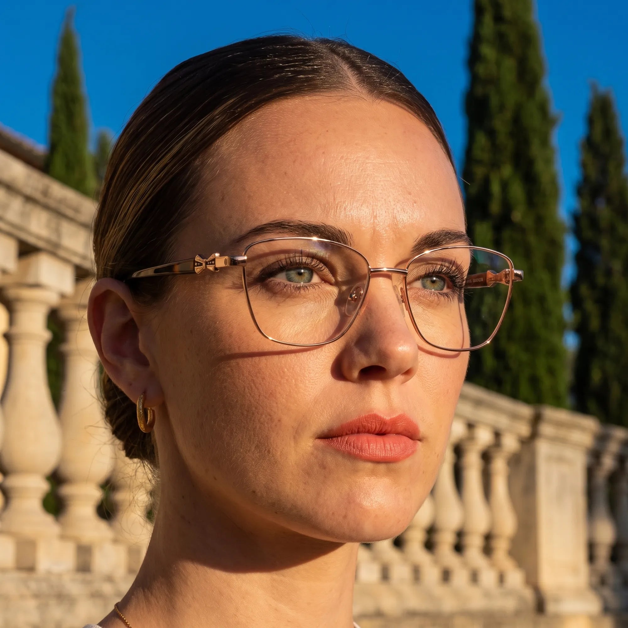 Fiore 22115 eyeglasses in brown, worn by a model – campaign portrait, golden-hour Italian villa terrace