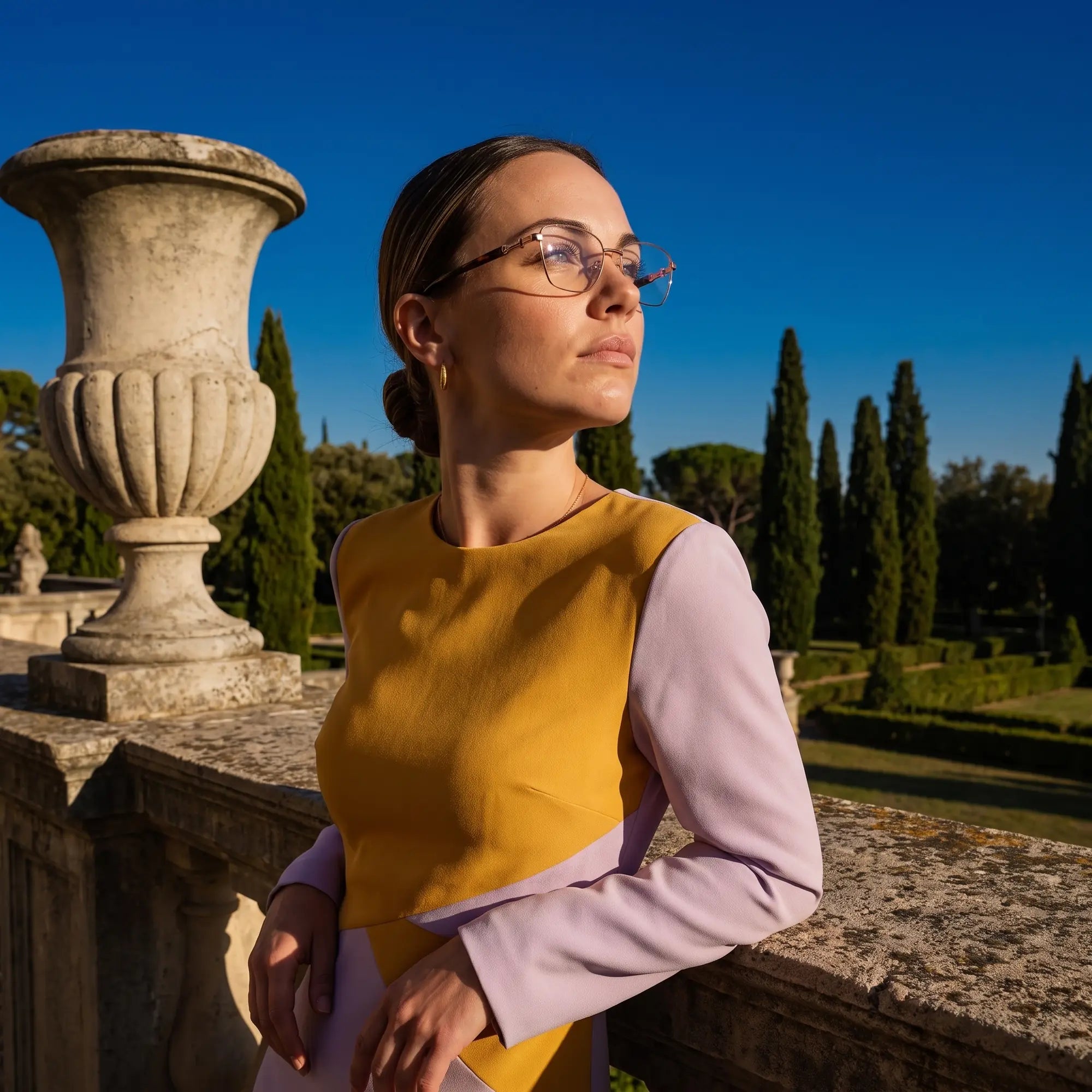 Fiore 22115 eyeglasses in brown, worn by a model – campaign portrait, dusk light over a cypress garden
