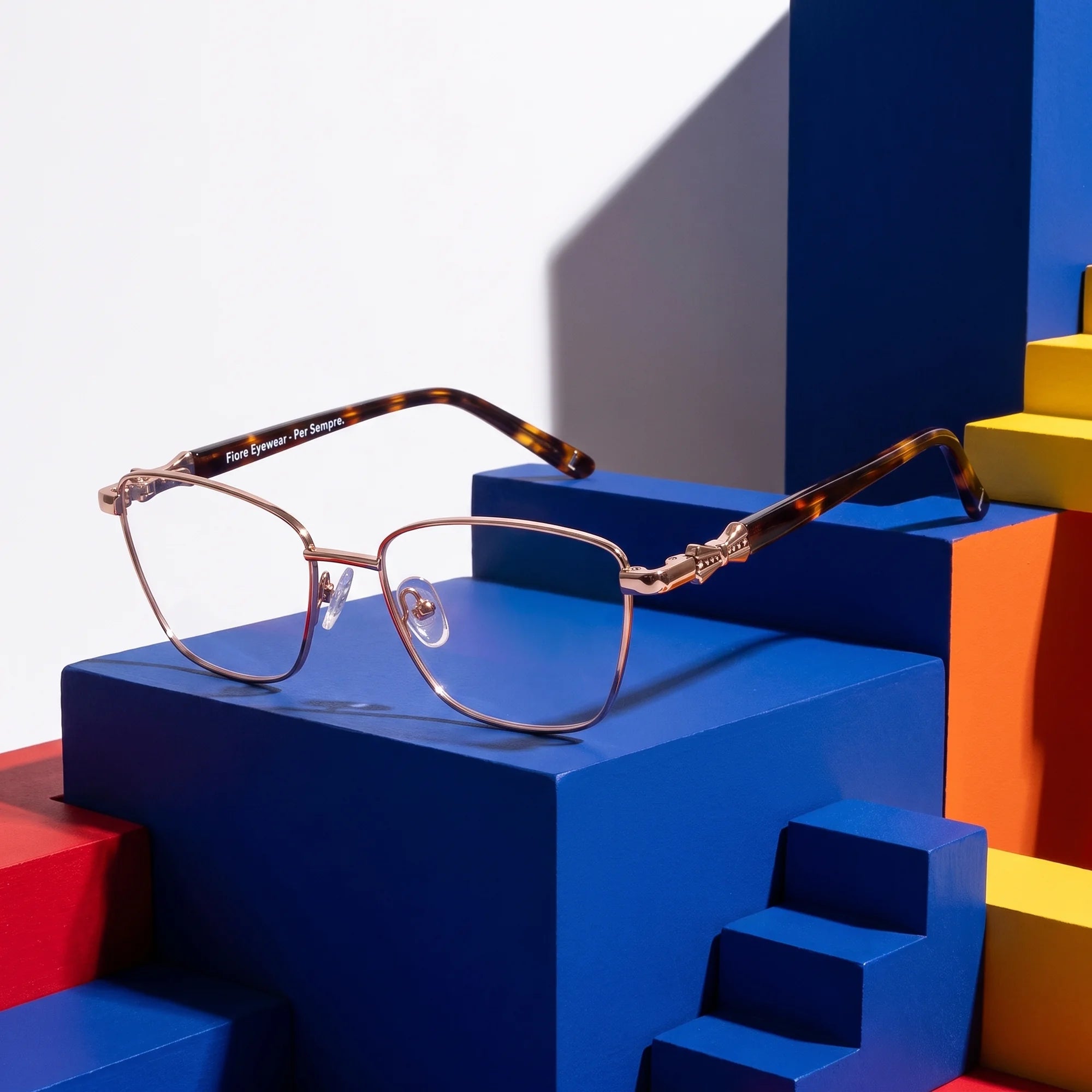 Fiore 22115 eyeglasses in brown – on bold primary color-block steps