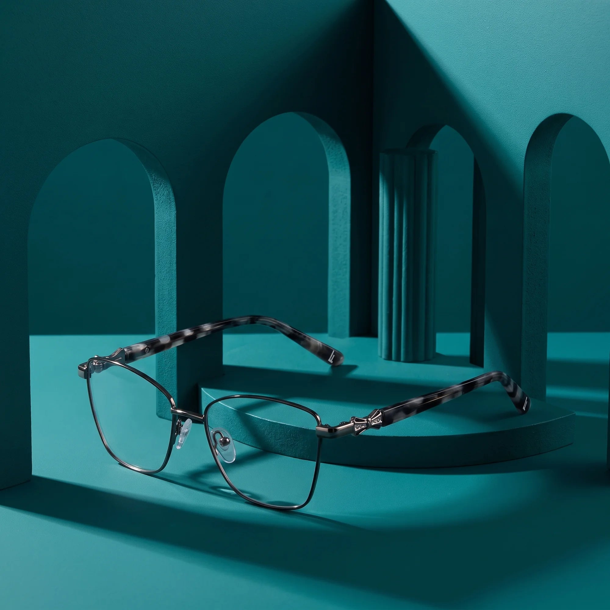 Fiore 22115 eyeglasses in black silver – still life among monochrome teal arches