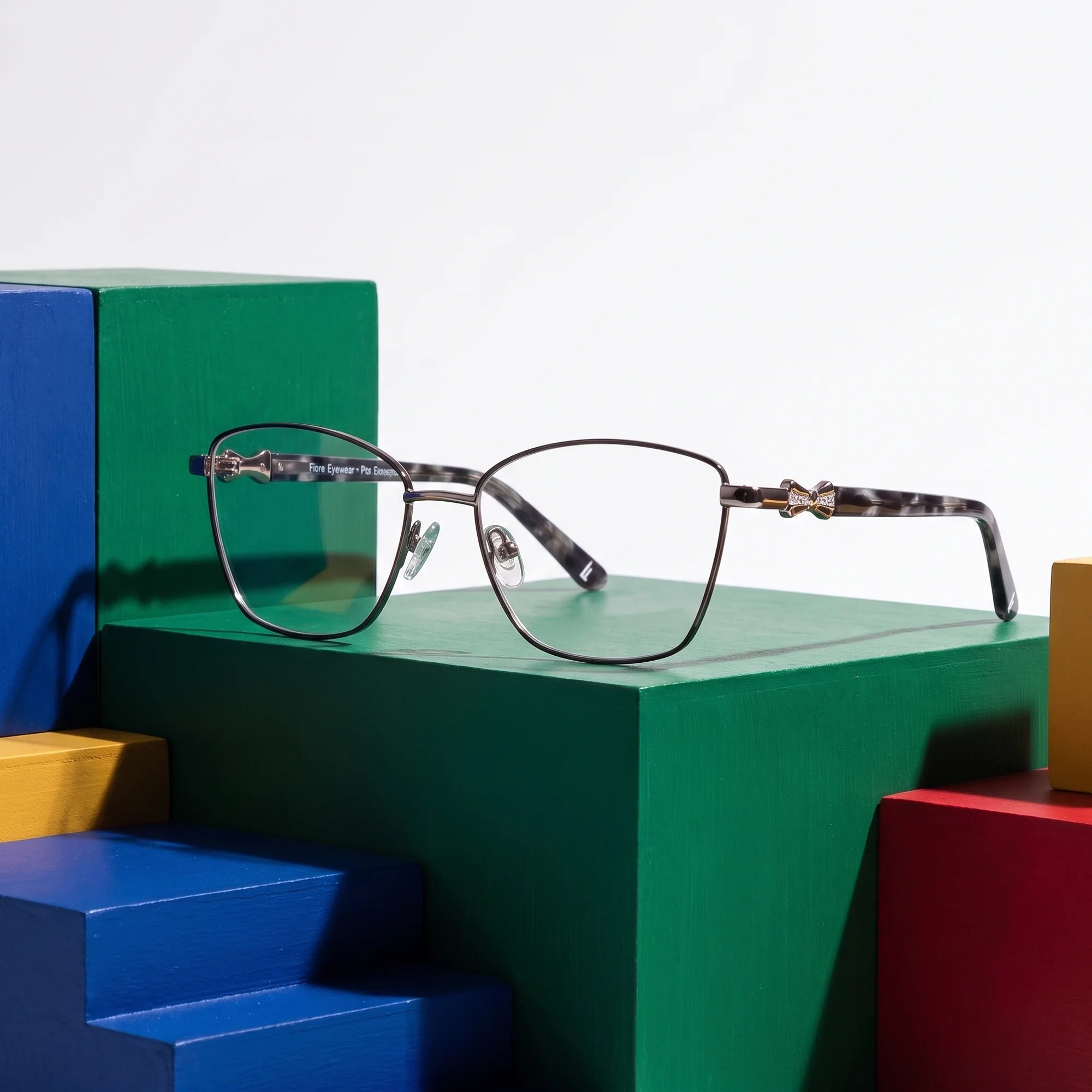 Fiore 22115 eyeglasses in black silver – on bold primary color-block steps