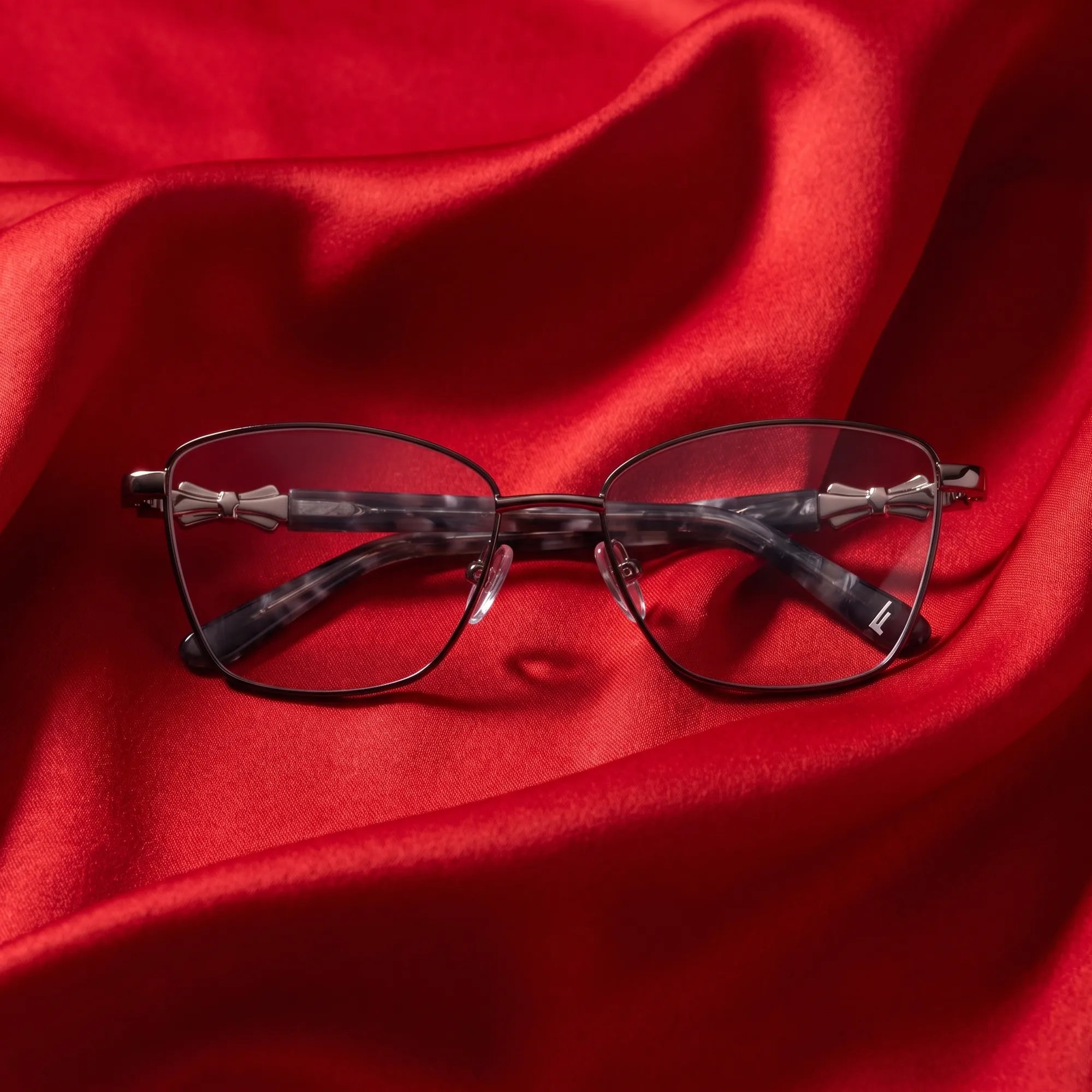 Fiore 22115 eyeglasses in black silver – nested in flowing vivid red silk