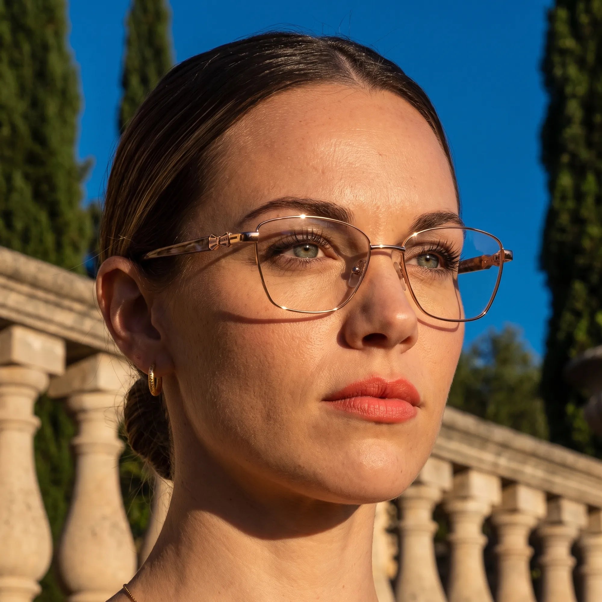 Fiore 22115 eyeglasses in gold, worn by a model – campaign portrait, golden-hour Italian villa terrace