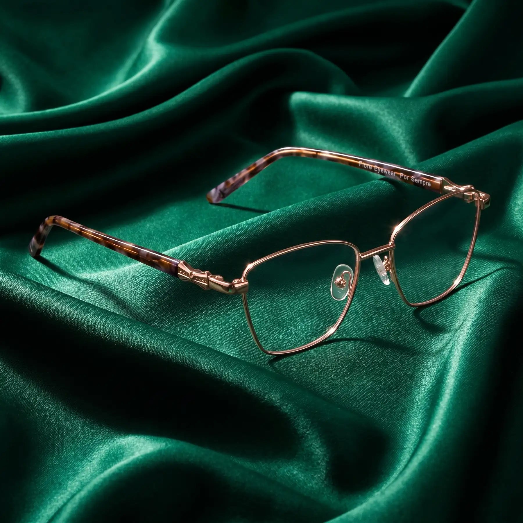 Fiore 22115 eyeglasses in gold – nested in flowing emerald silk