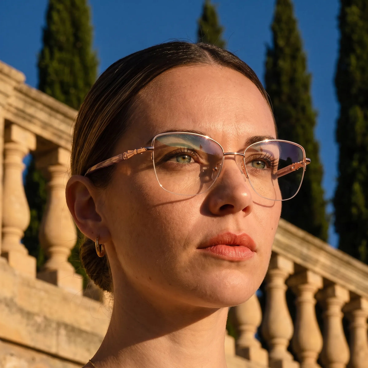 Fiore 22117 eyeglasses in gold, worn by a model – campaign portrait, golden-hour Italian villa terrace