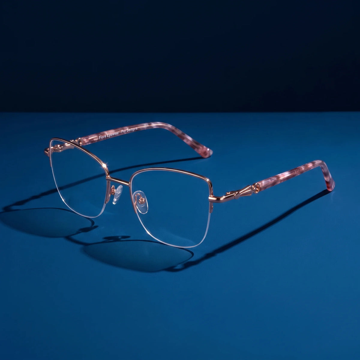 Fiore 22117 eyeglasses in gold – hero still life against a deep saturated color backdrop