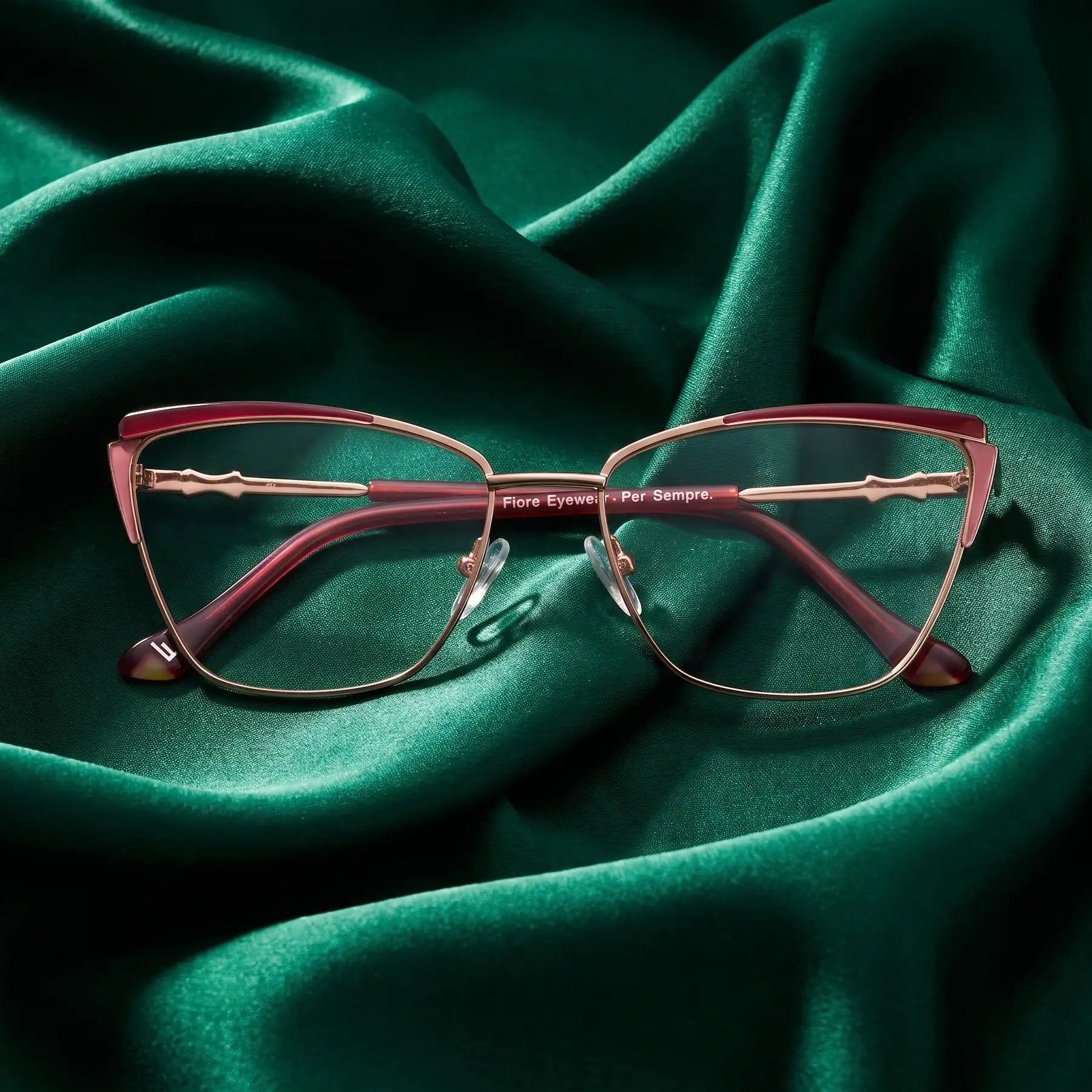 Fiore 3837 eyeglasses in red gold – nested in flowing emerald silk