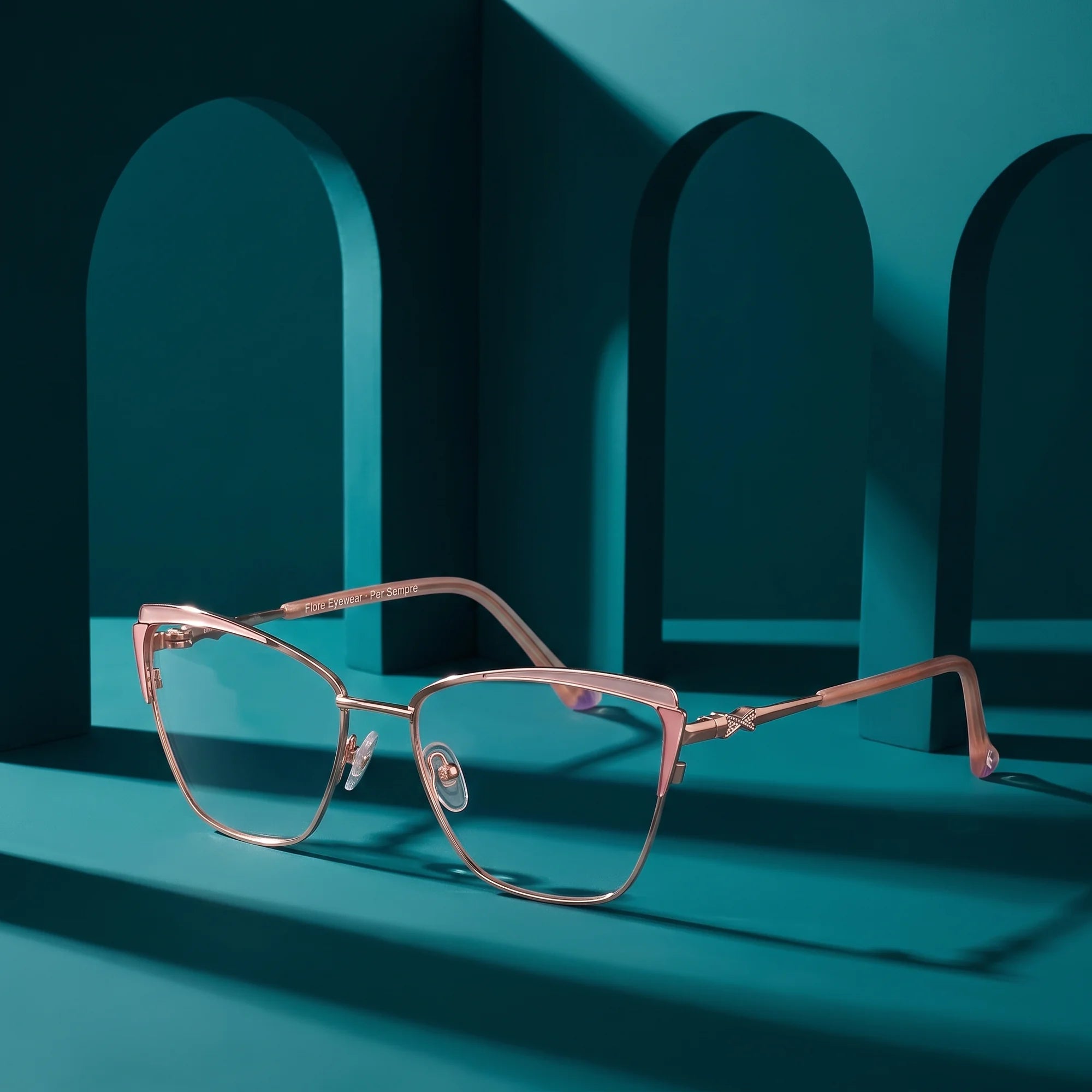 Fiore 3837 eyeglasses in pink gold – still life among monochrome teal arches