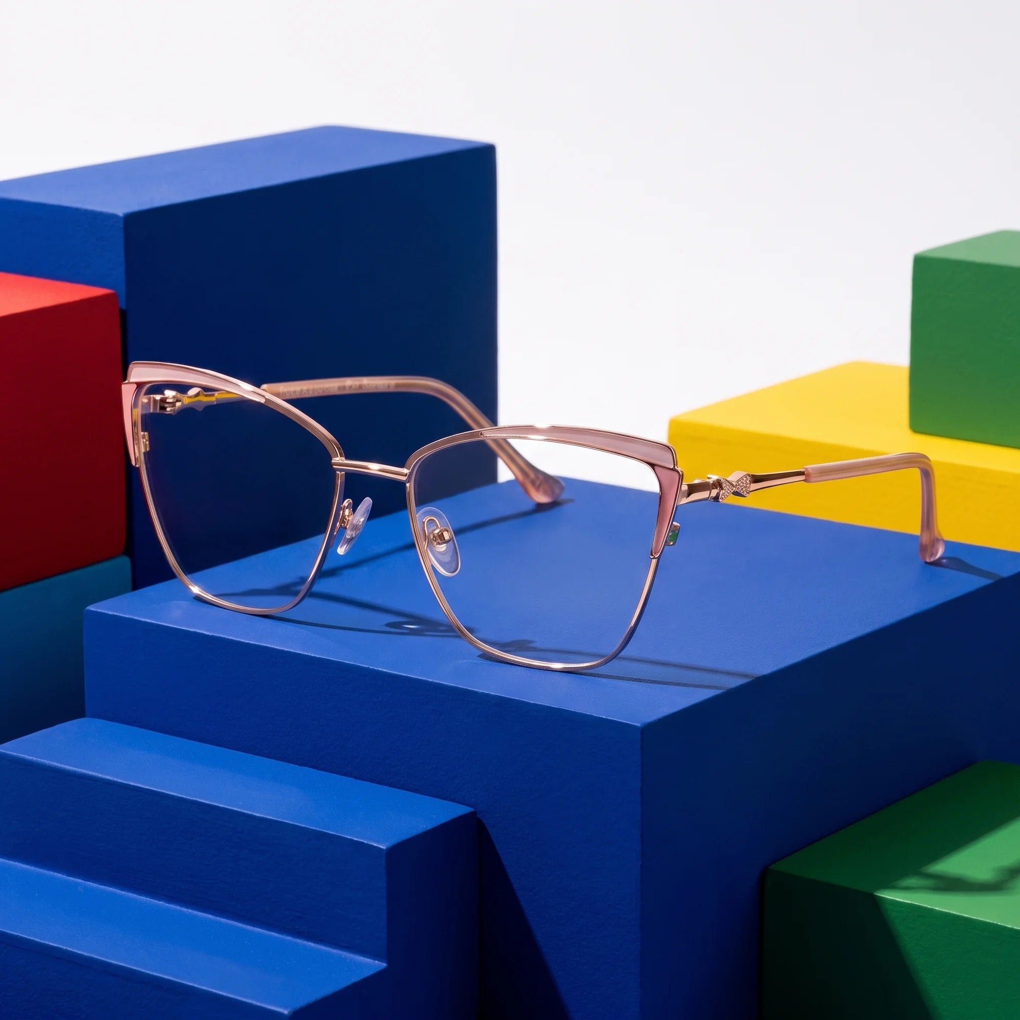Fiore 3837 eyeglasses in pink gold – on bold primary color-block steps