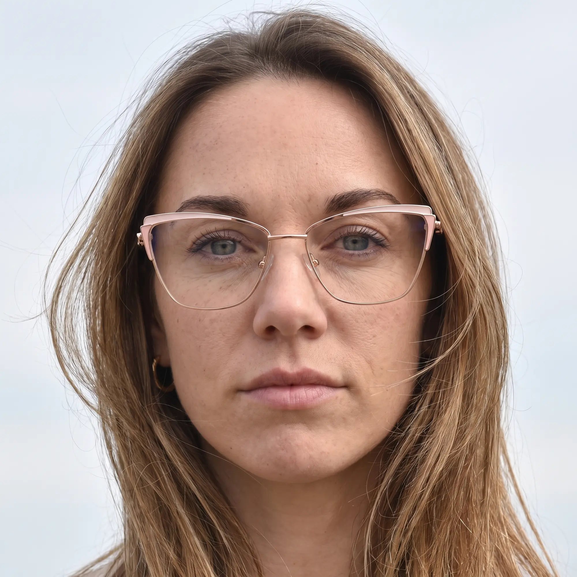 Fiore 3837 eyeglasses in pink gold, worn by a model – campaign portrait, floating together in milky summer water