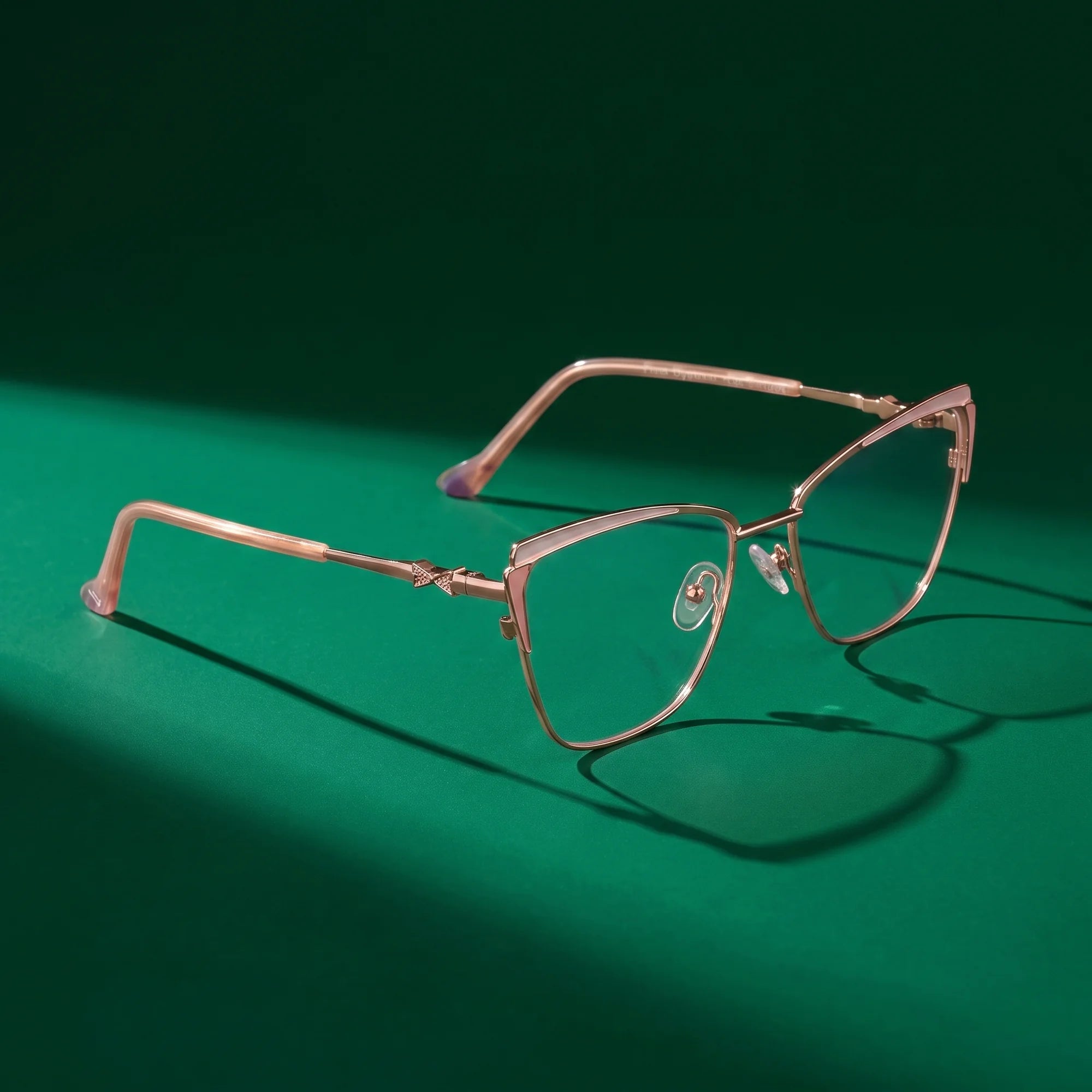 Fiore 3837 eyeglasses in pink gold – editorial still life on a saturated emerald set