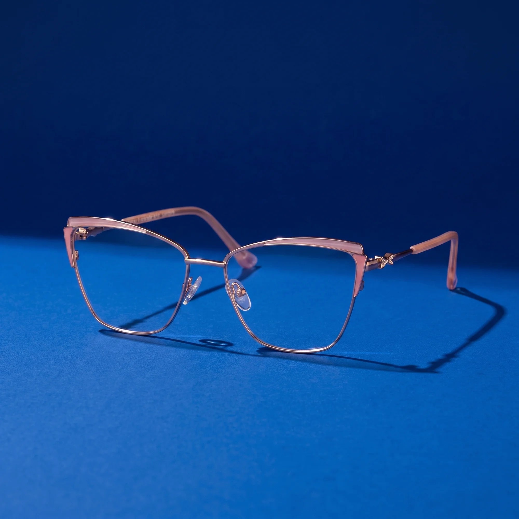 Fiore 3837 eyeglasses in pink gold – still life on a seamless cobalt studio backdrop