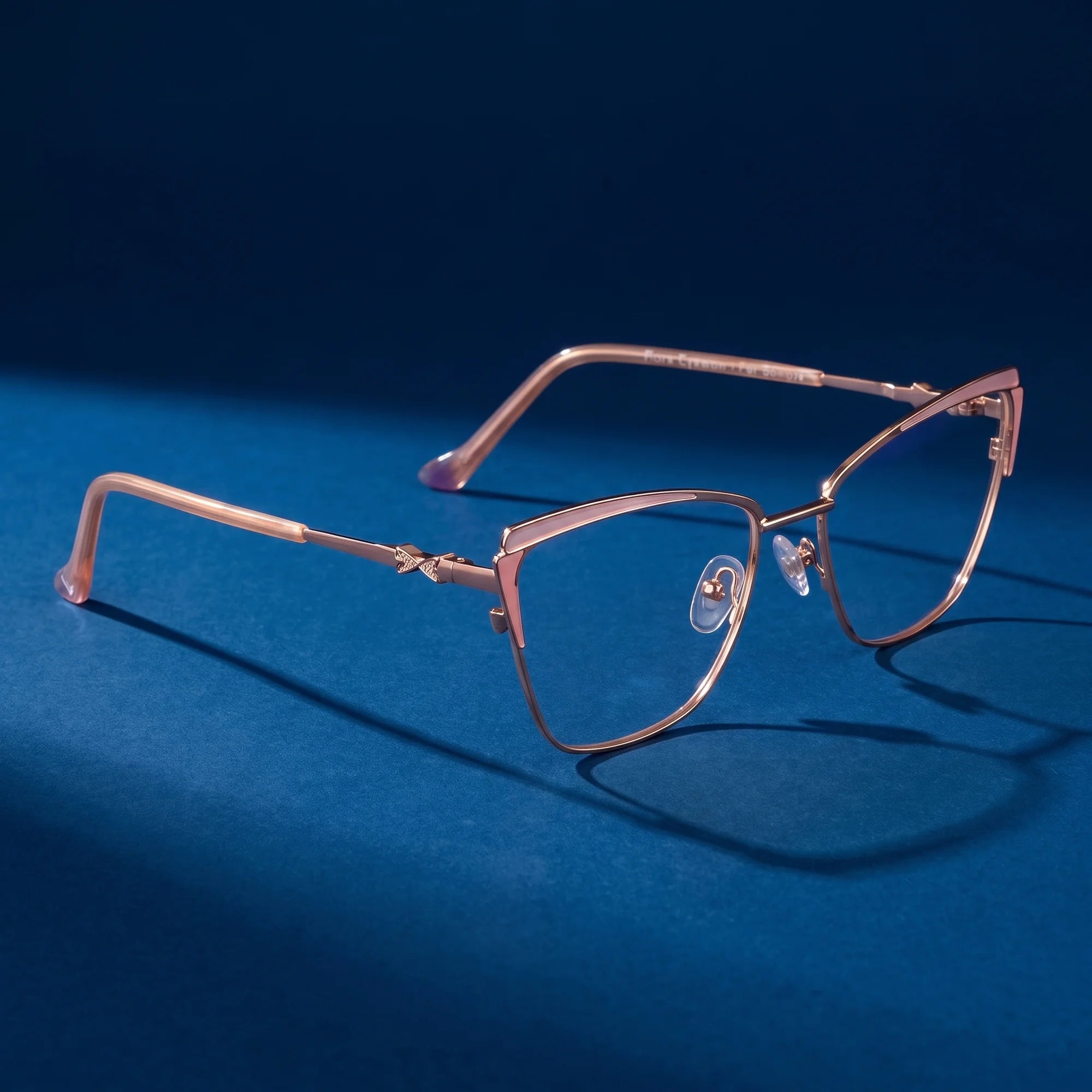 Fiore 3837 eyeglasses in pink gold – hero still life against a deep midnight blue backdrop