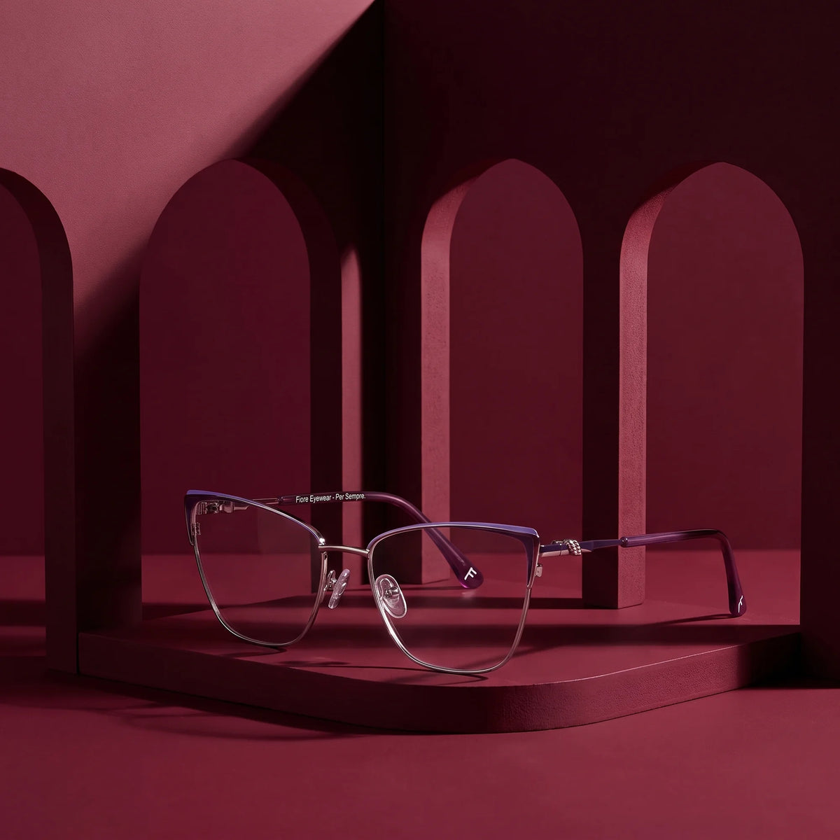 Fiore 3839 eyeglasses in purple silver – still life among monochrome burgundy arches
