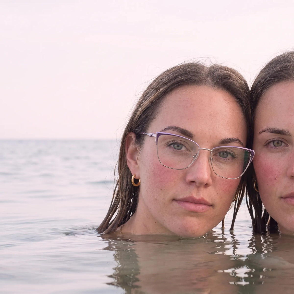 Fiore 3839 eyeglasses in purple silver, worn by a model – campaign portrait, wet-hair portrait in a calm summer sea