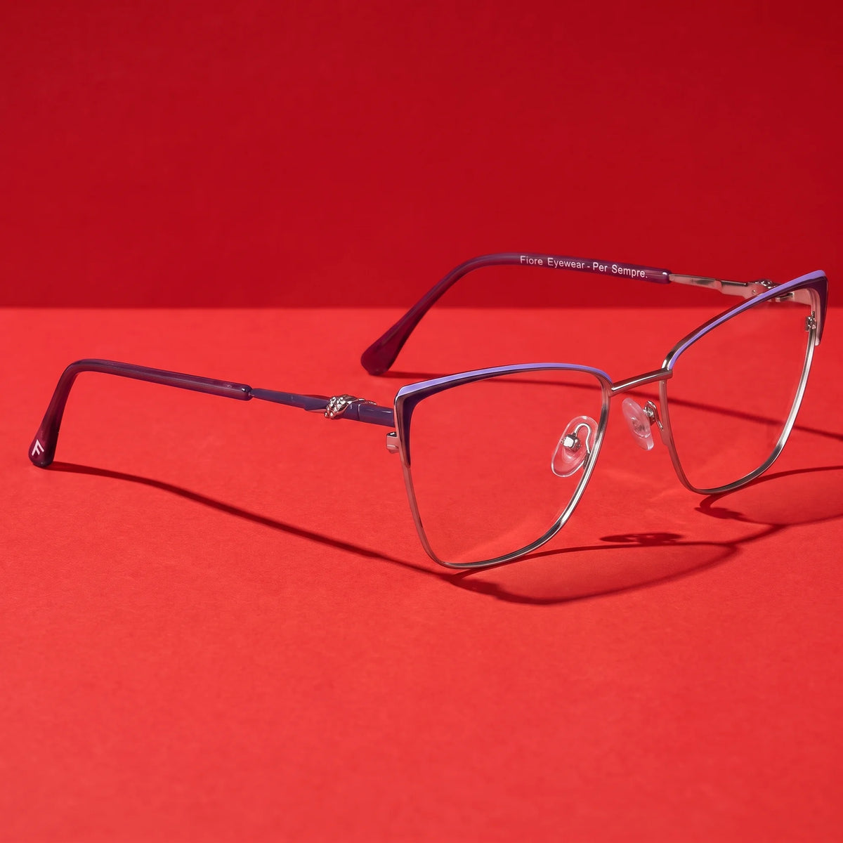 Fiore 3839 eyeglasses in purple silver – still life on a seamless vivid red studio backdrop