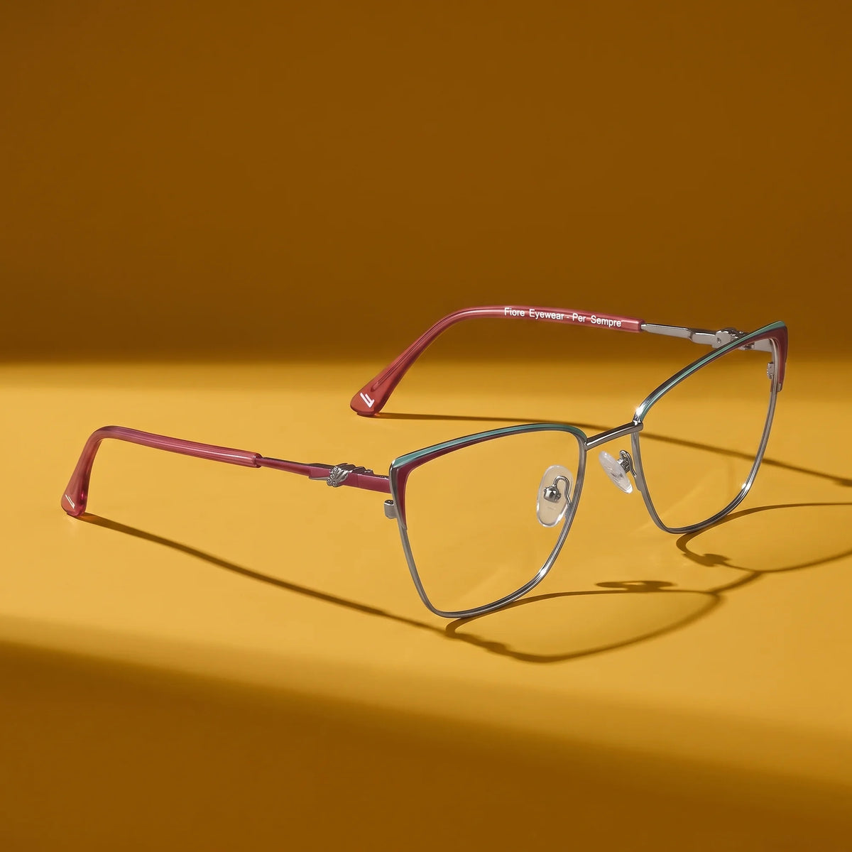 Fiore 3839 eyeglasses in red gun – hero still life against a deep mustard ochre backdrop