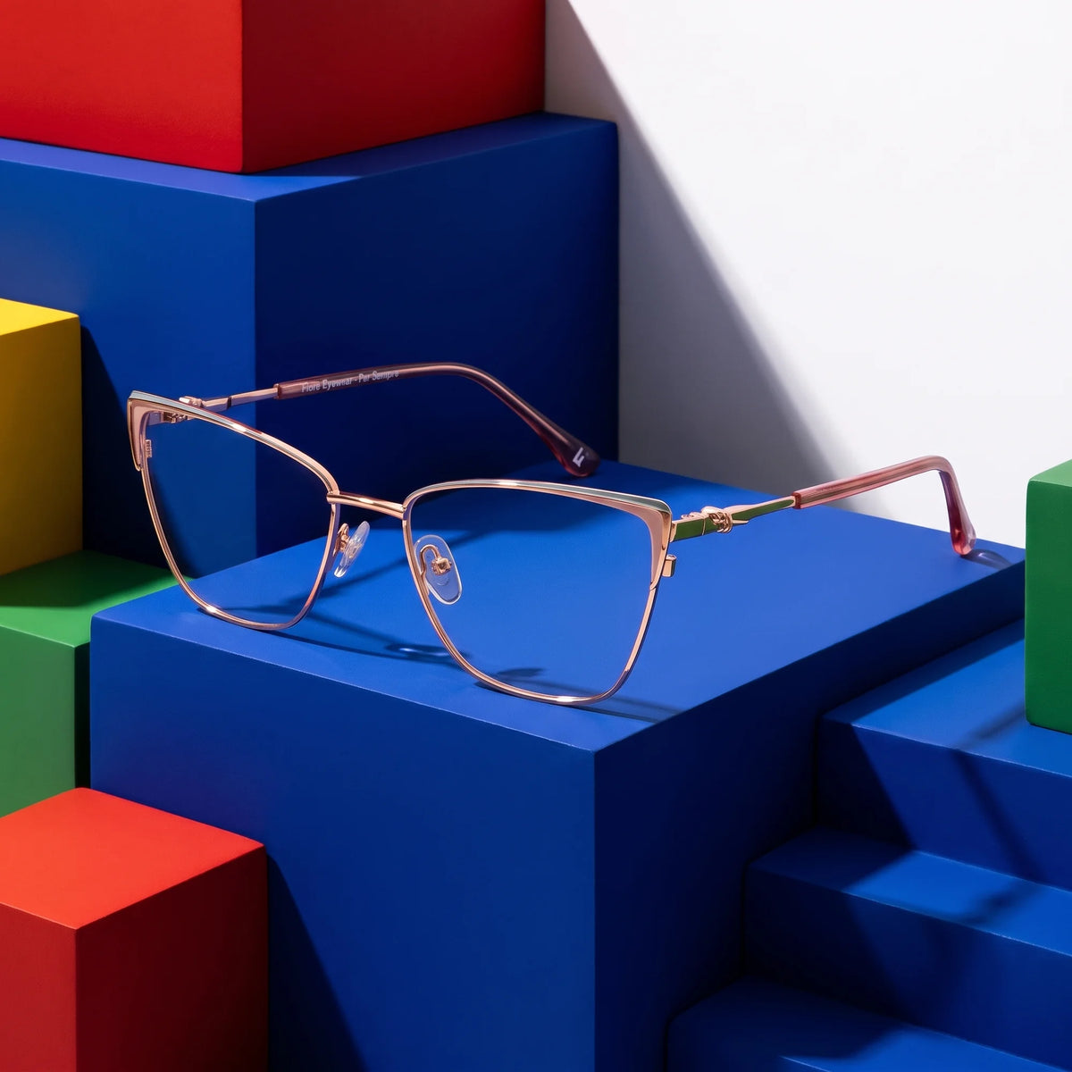 Fiore 3839 eyeglasses in pink gold – on bold primary color-block steps