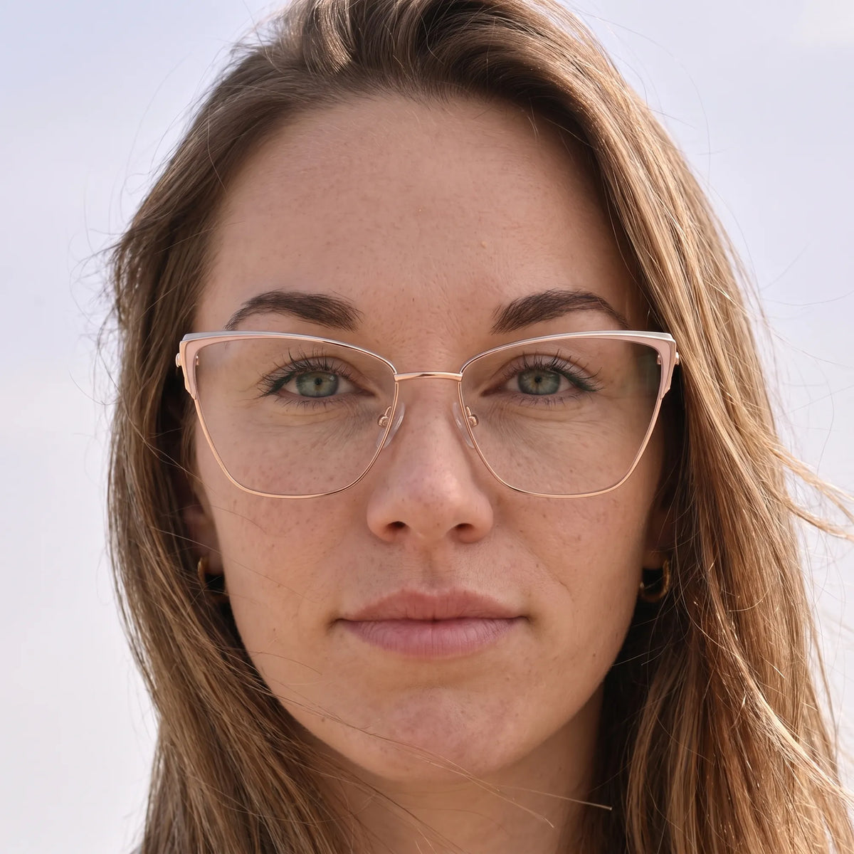 Fiore 3839 eyeglasses in pink gold, worn by a model – campaign portrait, floating together in milky summer water