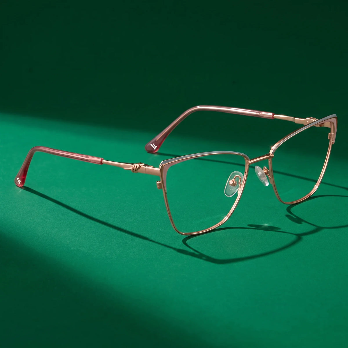 Fiore 3839 eyeglasses in pink gold – editorial still life on a saturated emerald set