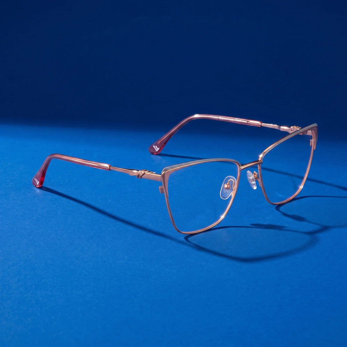 Fiore 3839 eyeglasses in pink gold – still life on a seamless cobalt studio backdrop