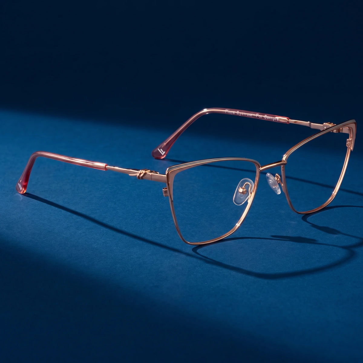 Fiore 3839 eyeglasses in pink gold – hero still life against a deep midnight blue backdrop
