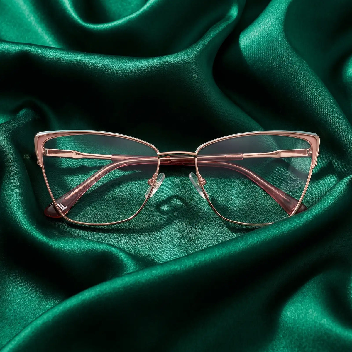 Fiore 3839 eyeglasses in pink gold – nested in flowing emerald silk