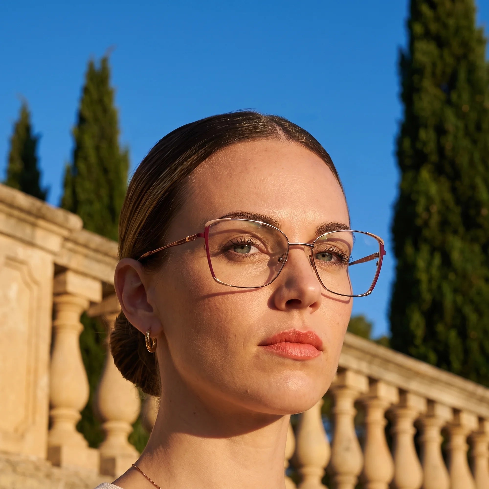Fiore 3916 eyeglasses in purple pink silver, worn by a model – campaign portrait, golden-hour Italian villa terrace