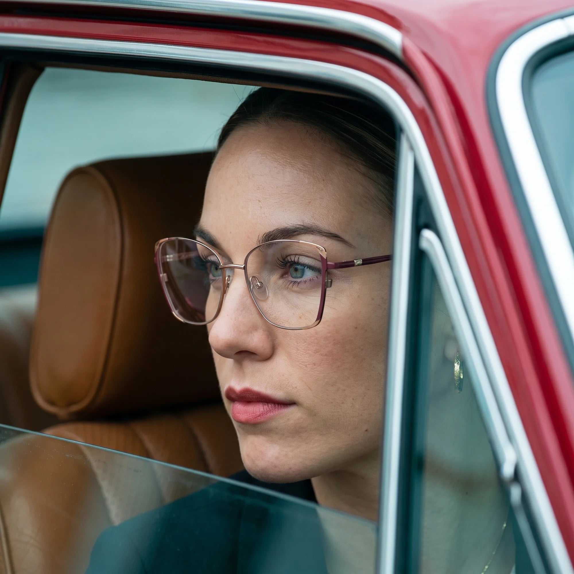 Fiore 3916 eyeglasses in purple pink silver, worn by a model – campaign portrait, gaze through a classic red car window