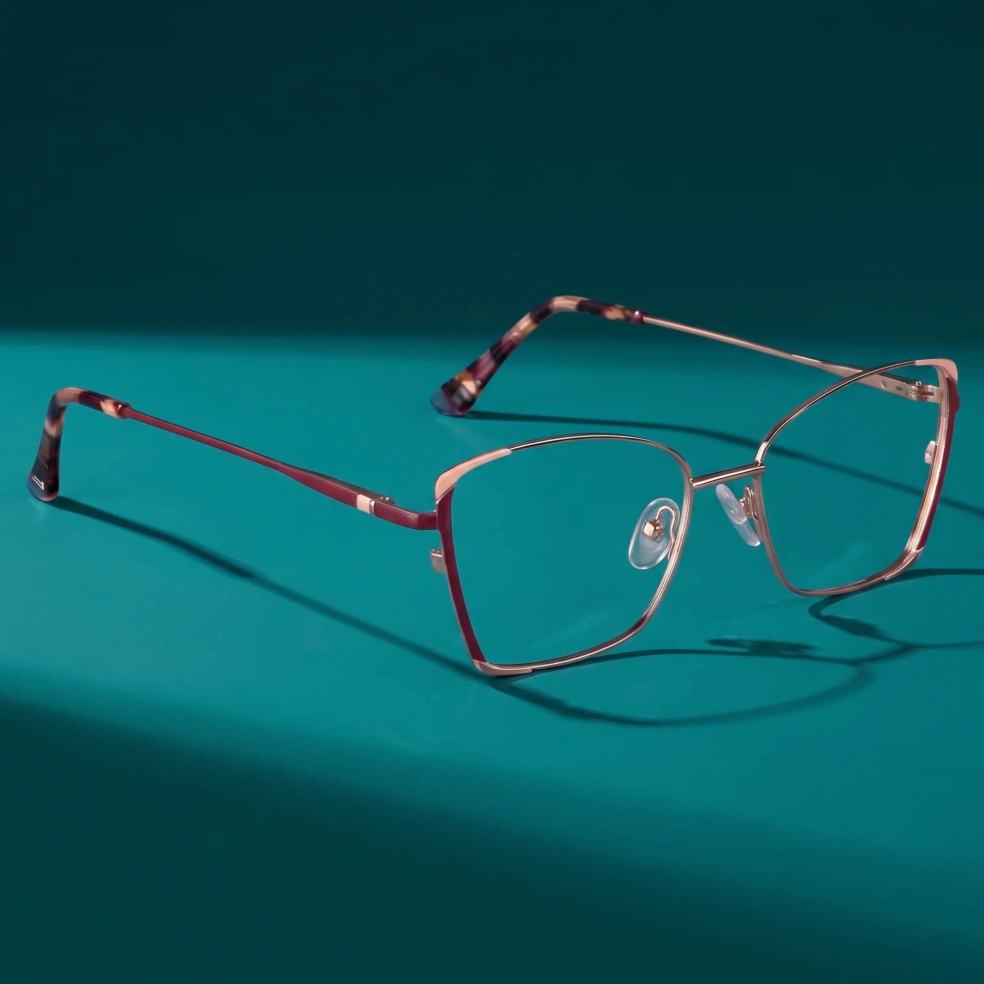 Fiore 3916 eyeglasses in purple pink silver – still life on a seamless teal studio backdrop