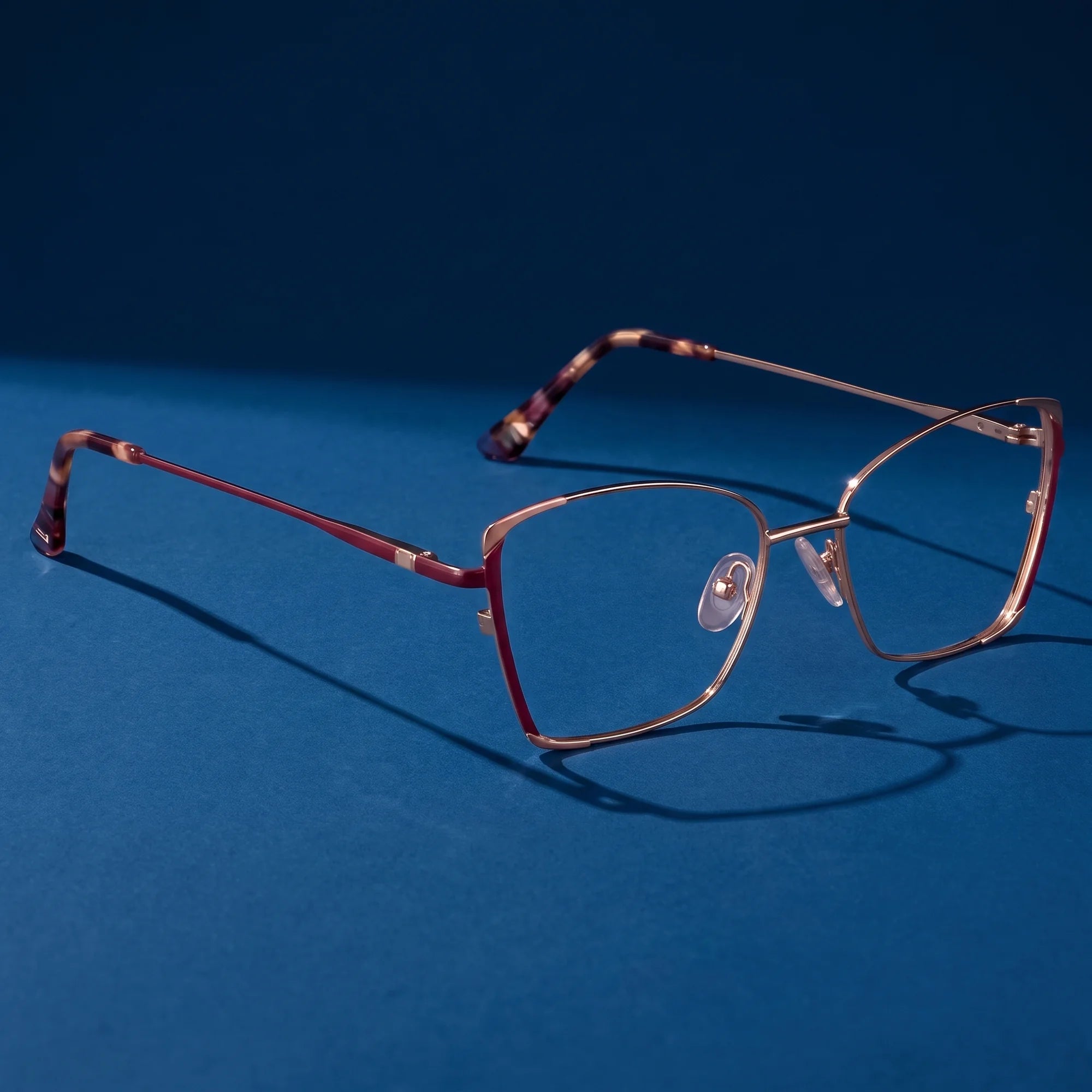Fiore 3916 eyeglasses in purple pink silver – hero still life against a deep midnight blue backdrop