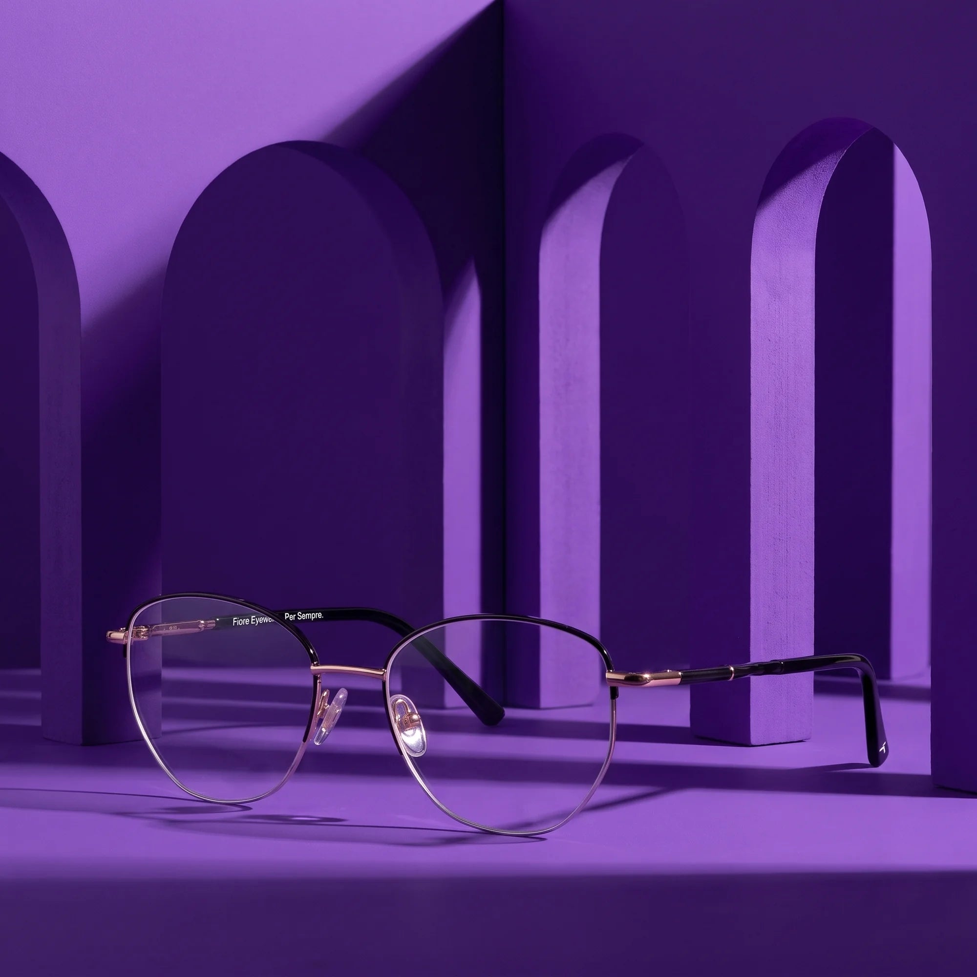 Fiore 3921 eyeglasses in black gold – staged on a sculptural violet architecture set