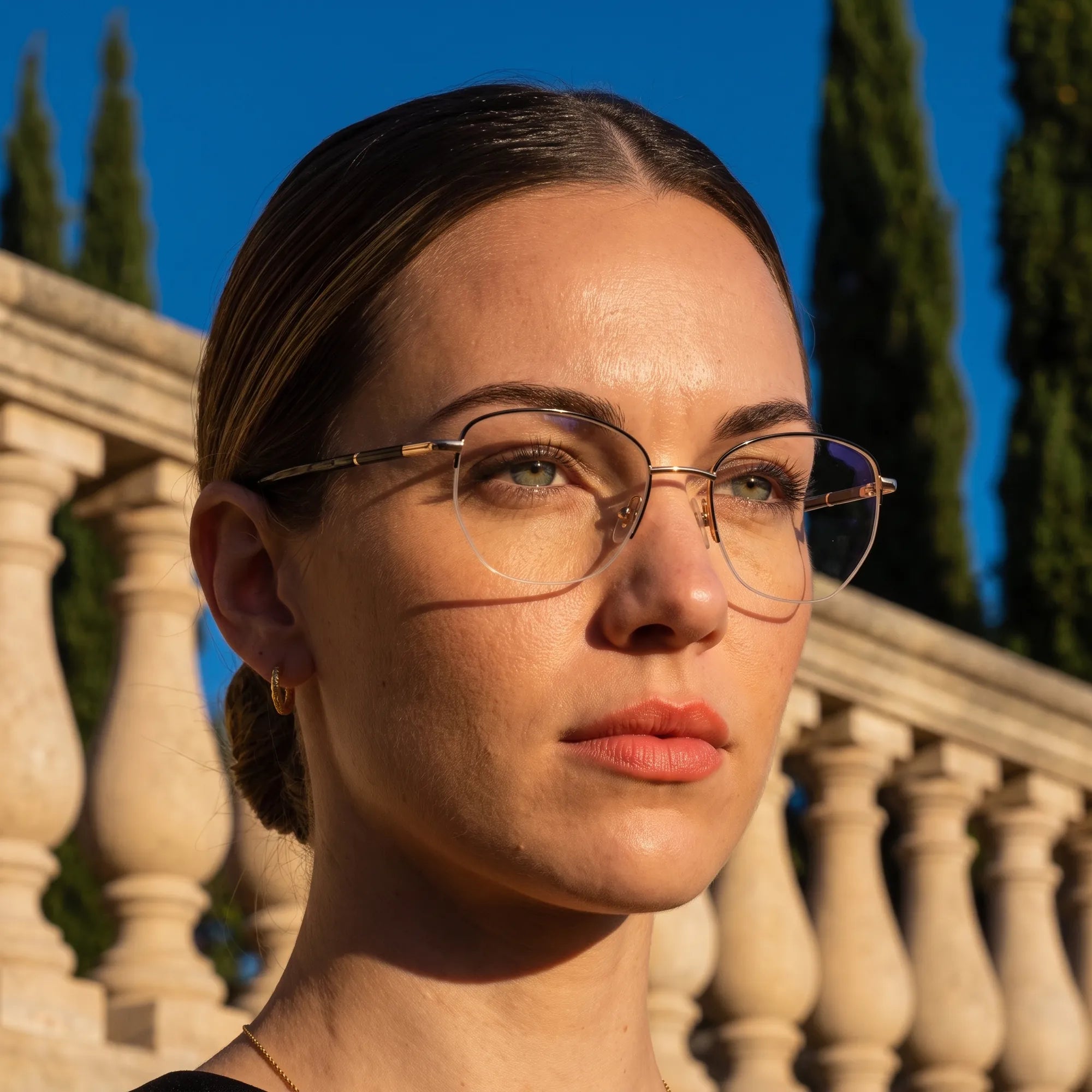 Fiore 3921 eyeglasses in black gold, worn by a model – campaign portrait, golden-hour Italian villa terrace