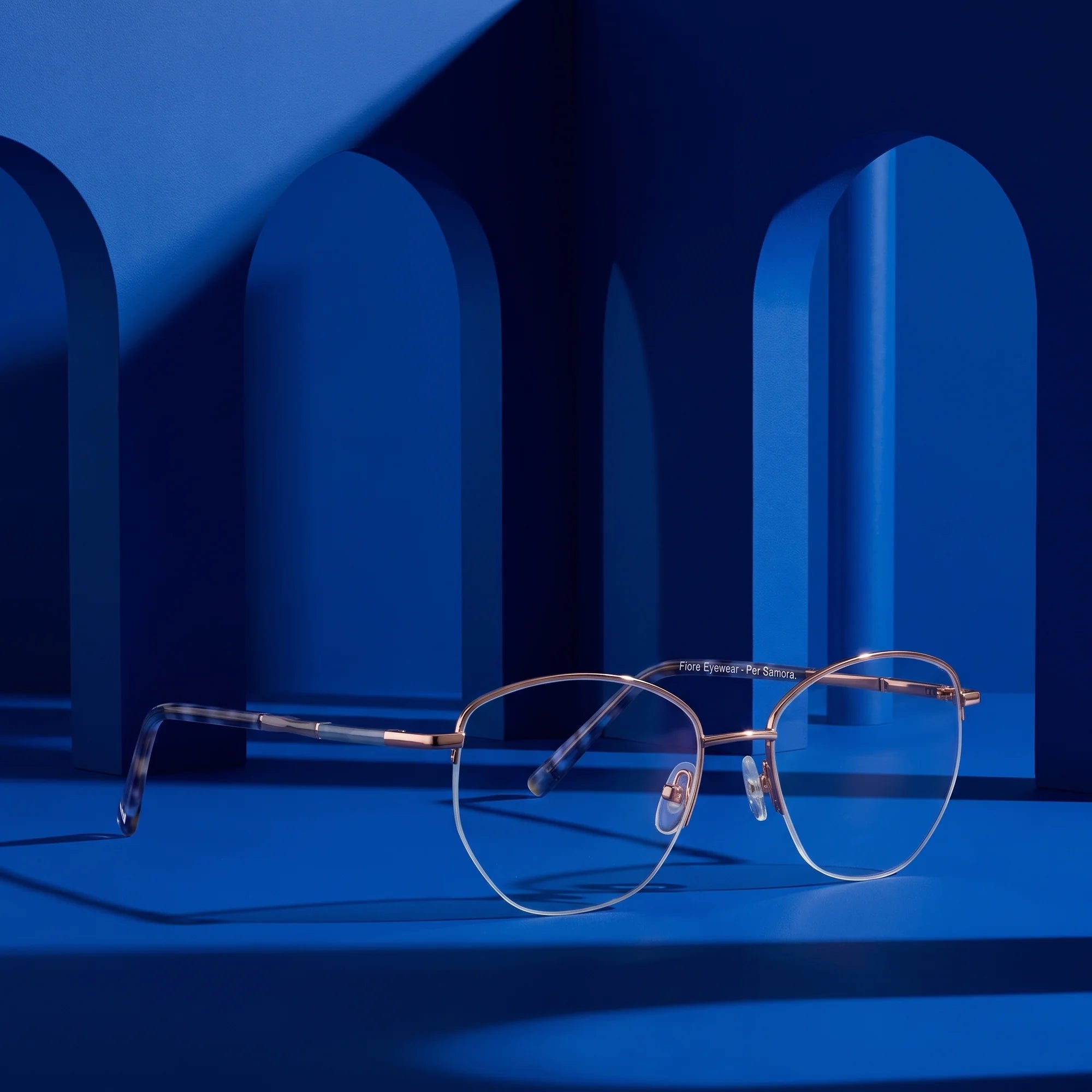 Fiore 3921 eyeglasses in grey brown – staged on a sculptural cobalt architecture set