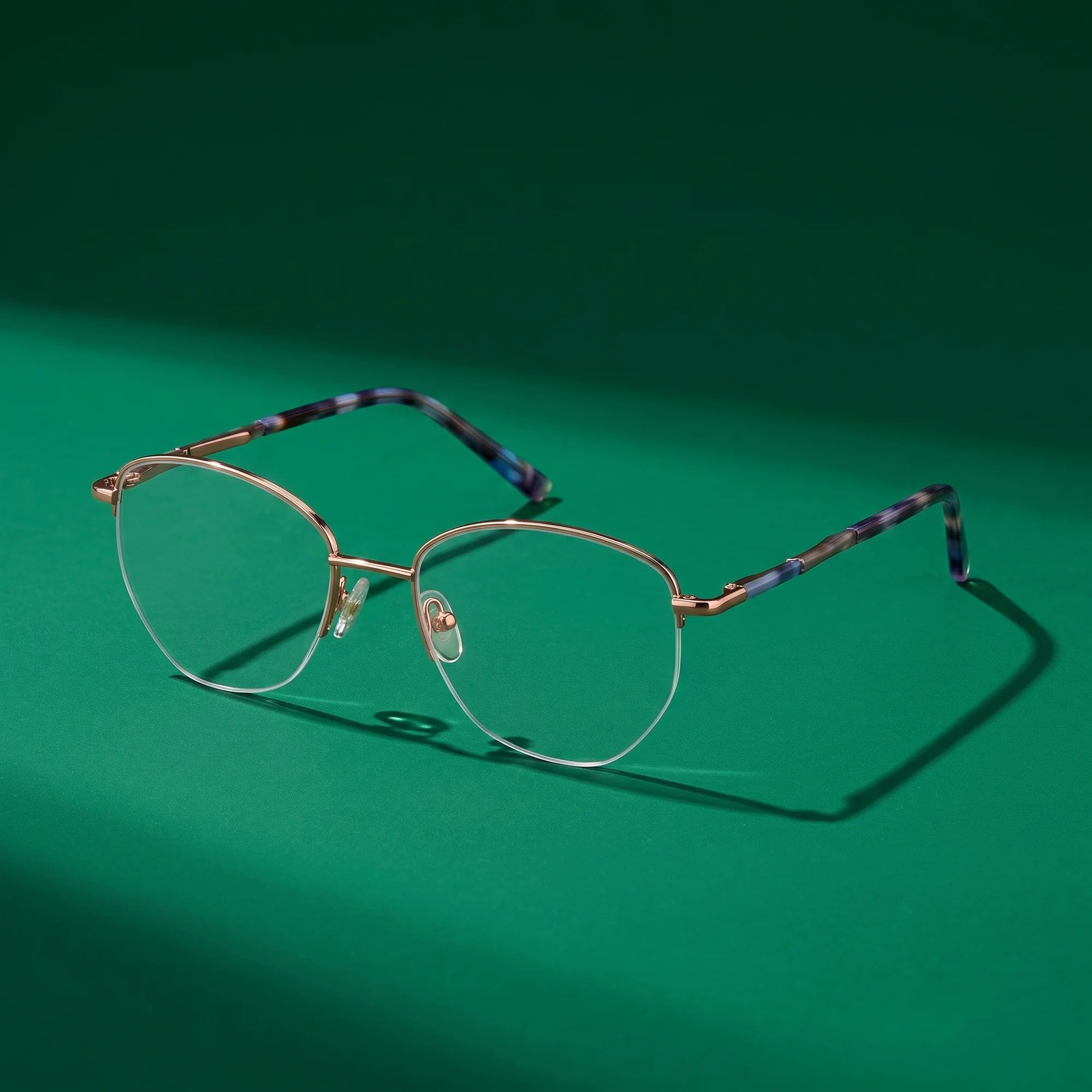 Fiore 3921 eyeglasses in grey brown – still life on a seamless emerald studio backdrop