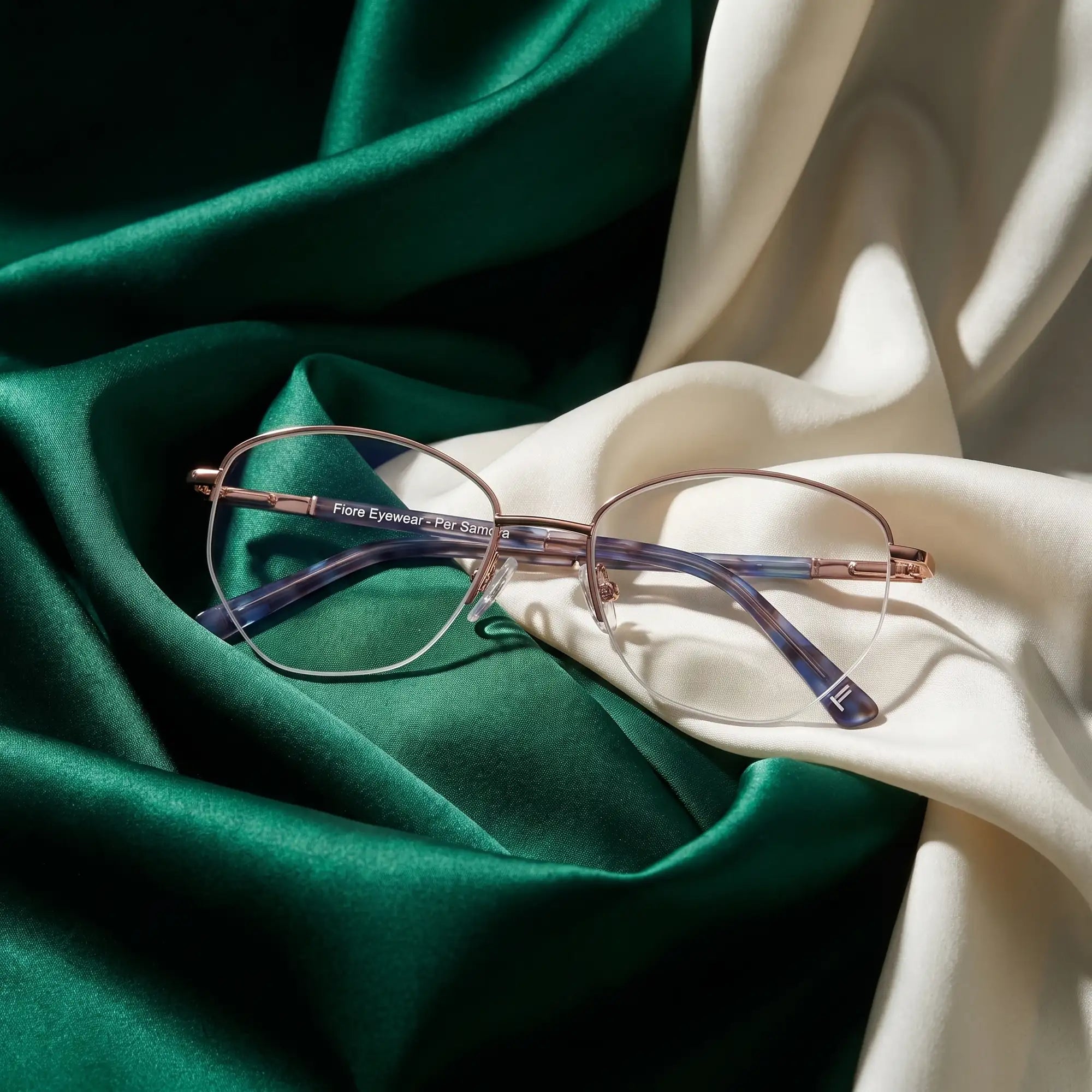 Fiore 3921 eyeglasses in grey brown – resting on draped emerald and ivory silk