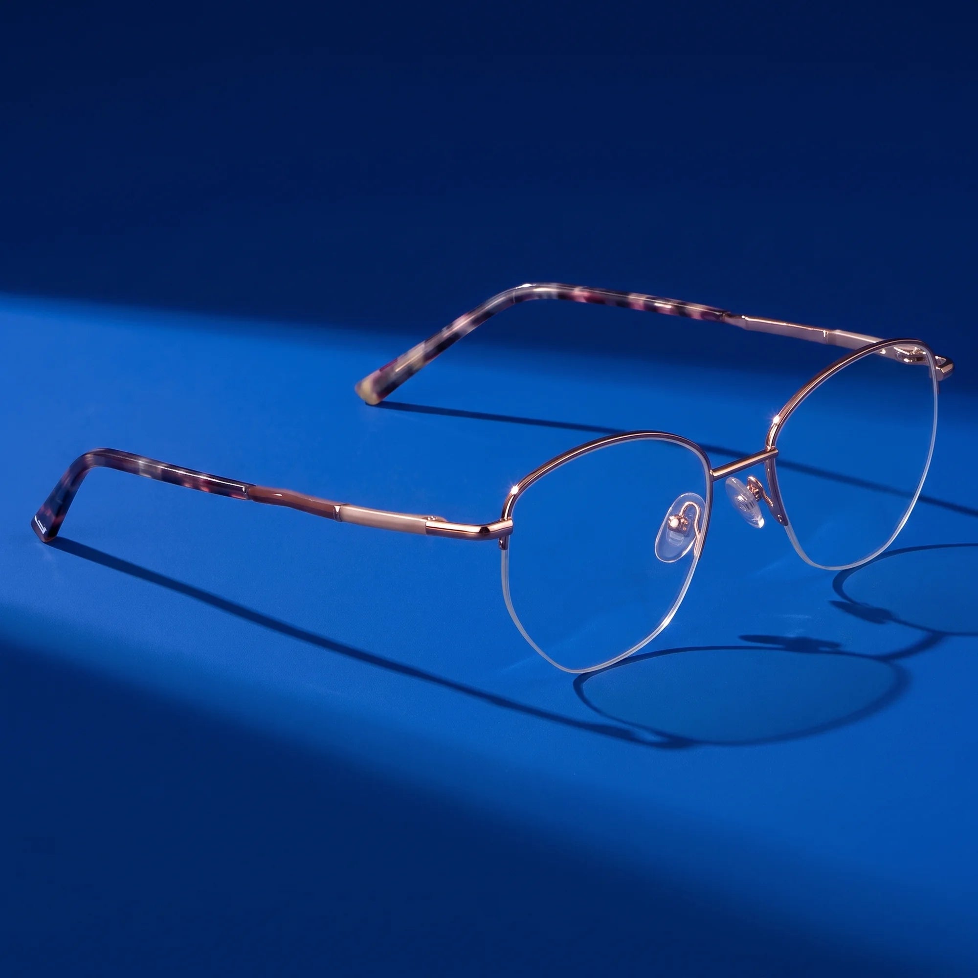 Fiore 3921 eyeglasses in brown gold – editorial still life on a saturated cobalt set