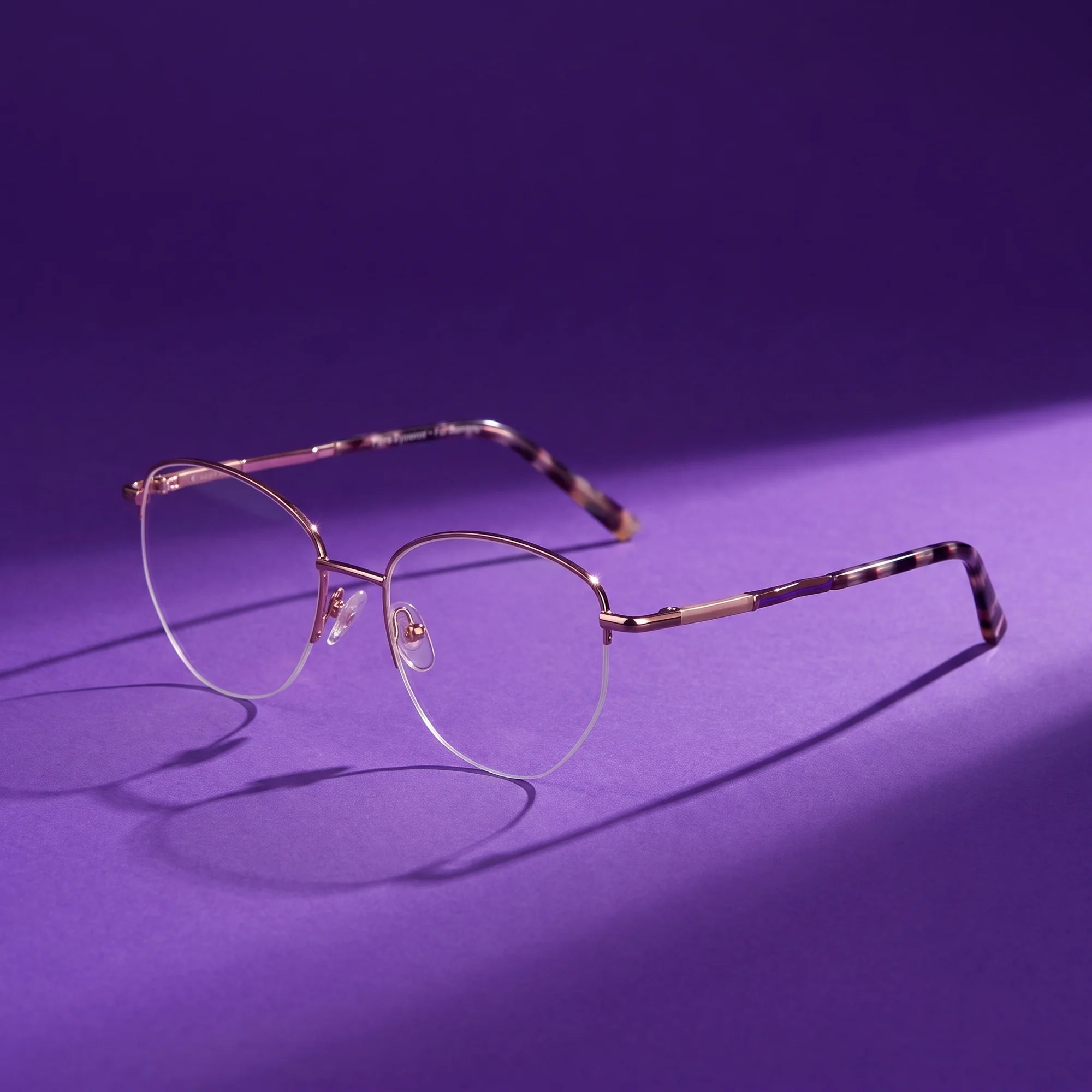 Fiore 3921 eyeglasses in brown gold – hero still life against a deep violet backdrop