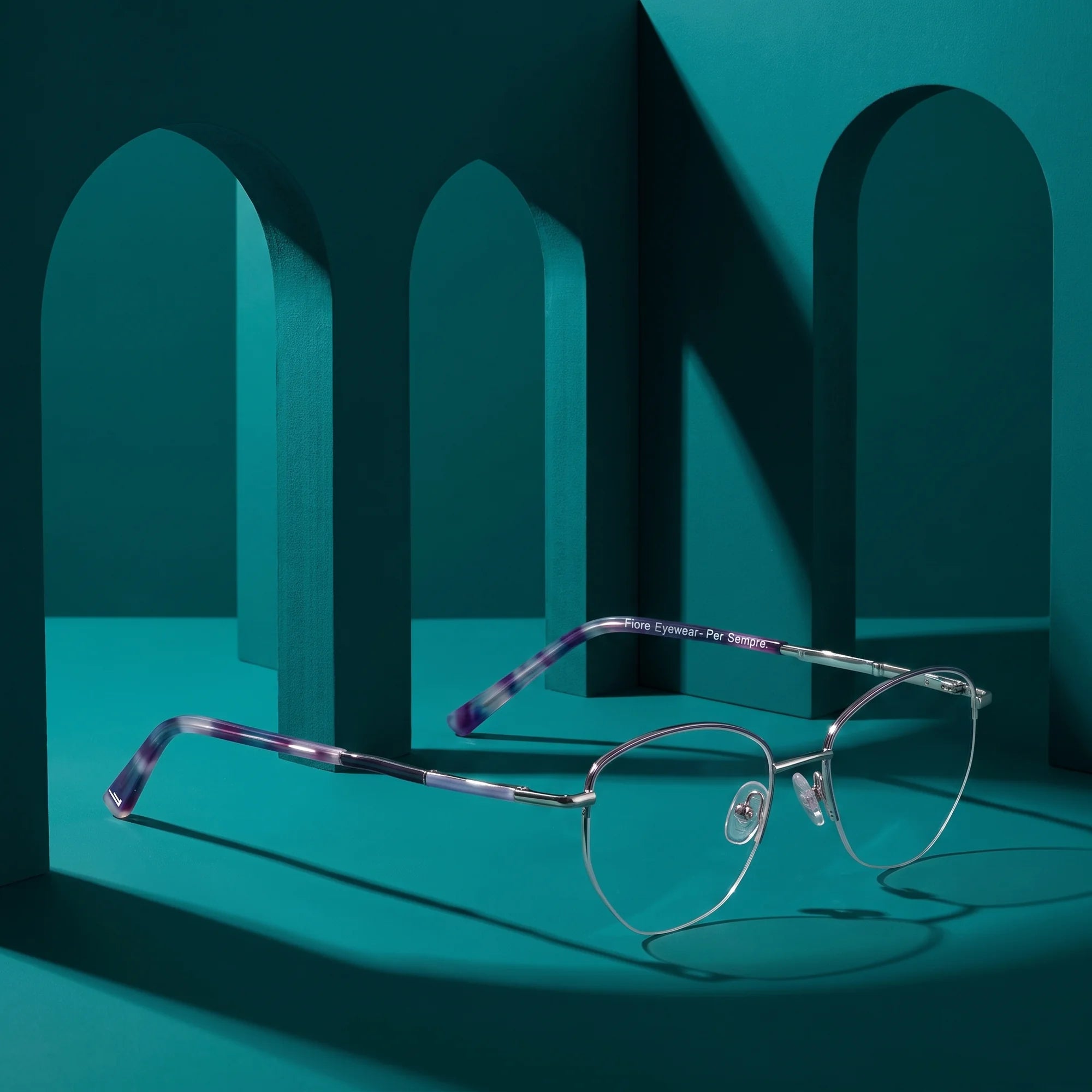 Fiore 3921 eyeglasses in purple silver – still life among monochrome teal arches