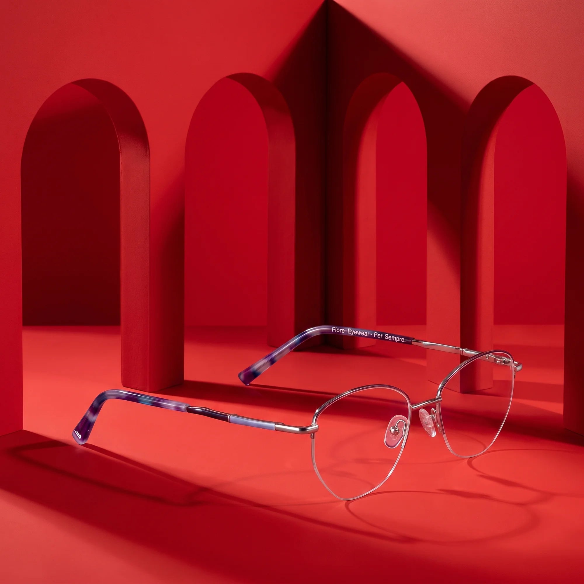 Fiore 3921 eyeglasses in purple silver – staged on a sculptural vivid red architecture set