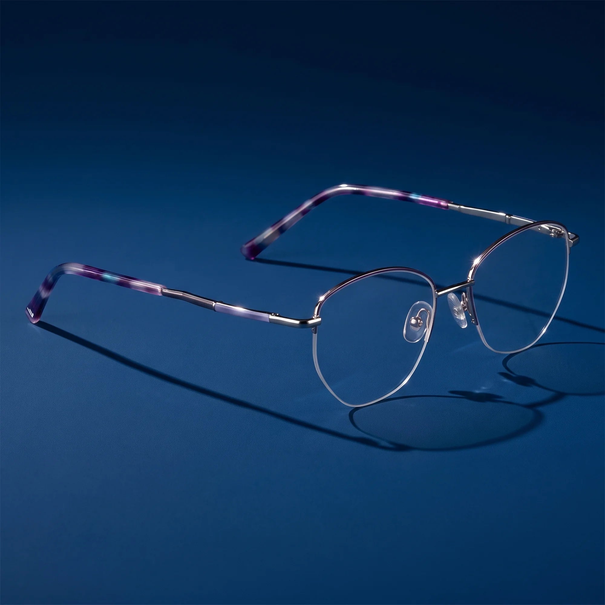 Fiore 3921 eyeglasses in purple silver – hero still life against a deep midnight blue backdrop