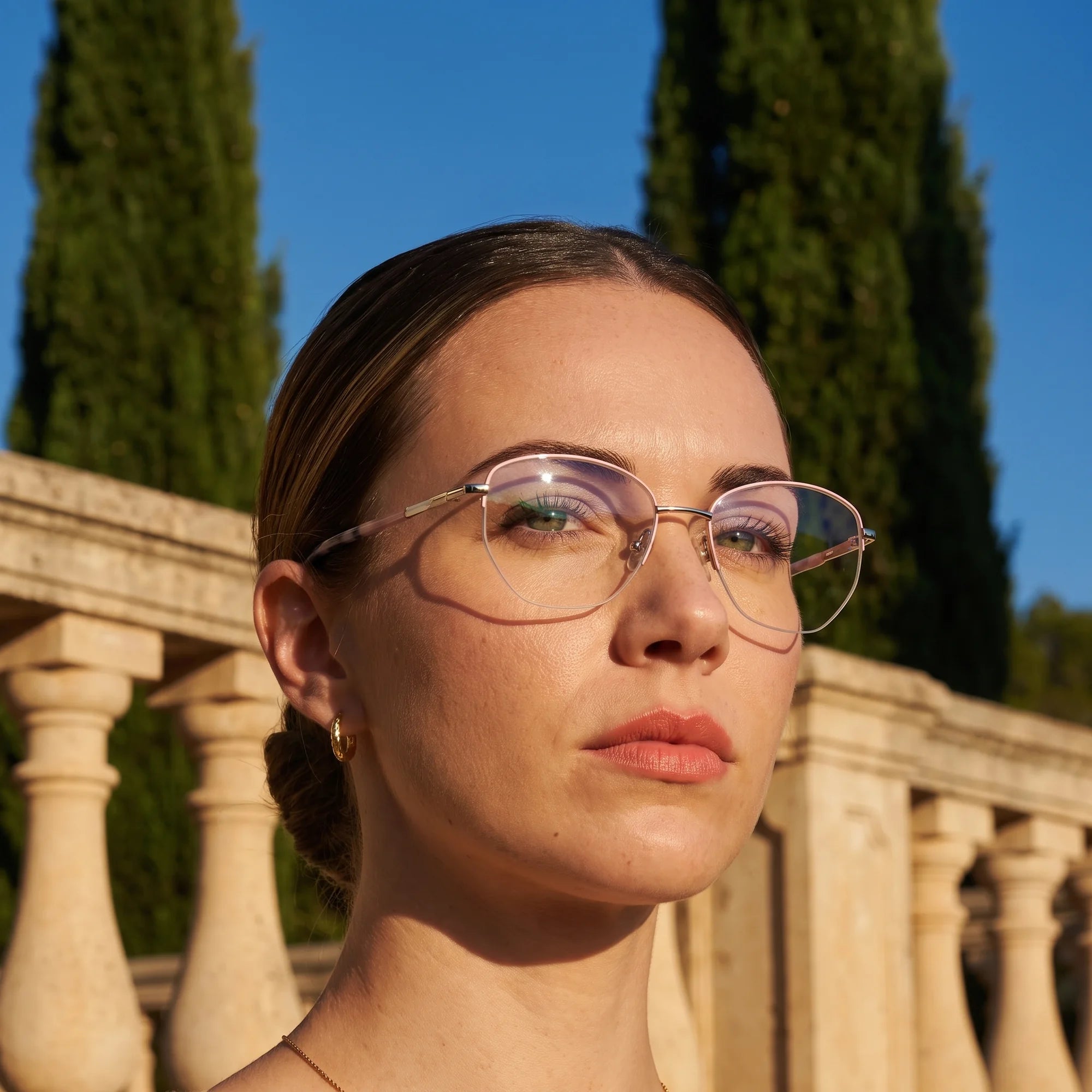 Fiore 3921 eyeglasses in pink silver, worn by a model – campaign portrait, golden-hour Italian villa terrace