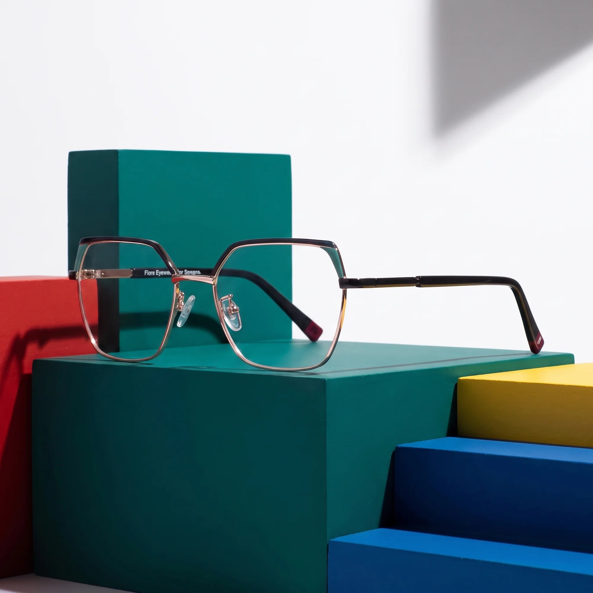 Fiore 3971 eyeglasses in black gold – on bold primary color-block steps