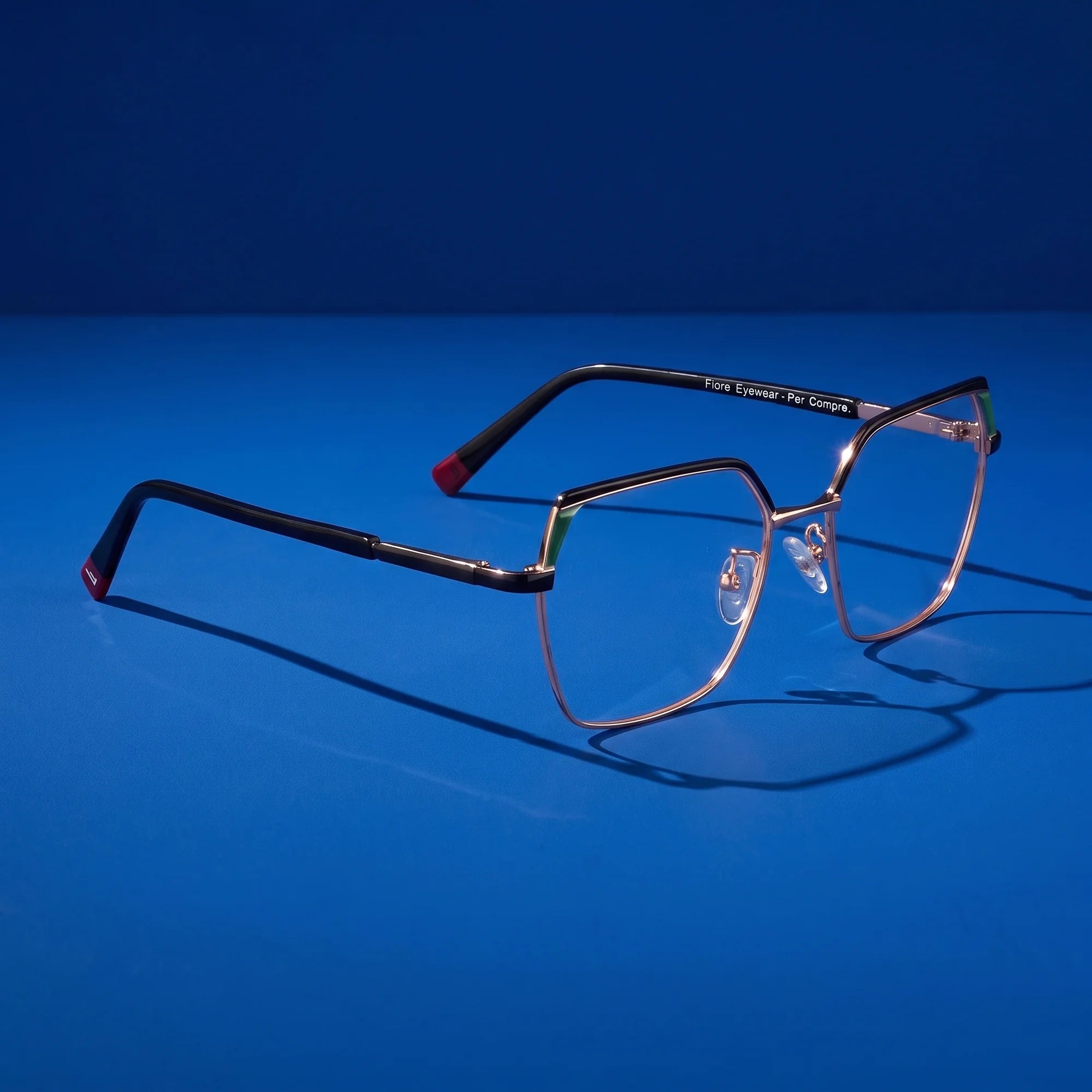 Fiore 3971 eyeglasses in black gold – editorial still life on a saturated cobalt set